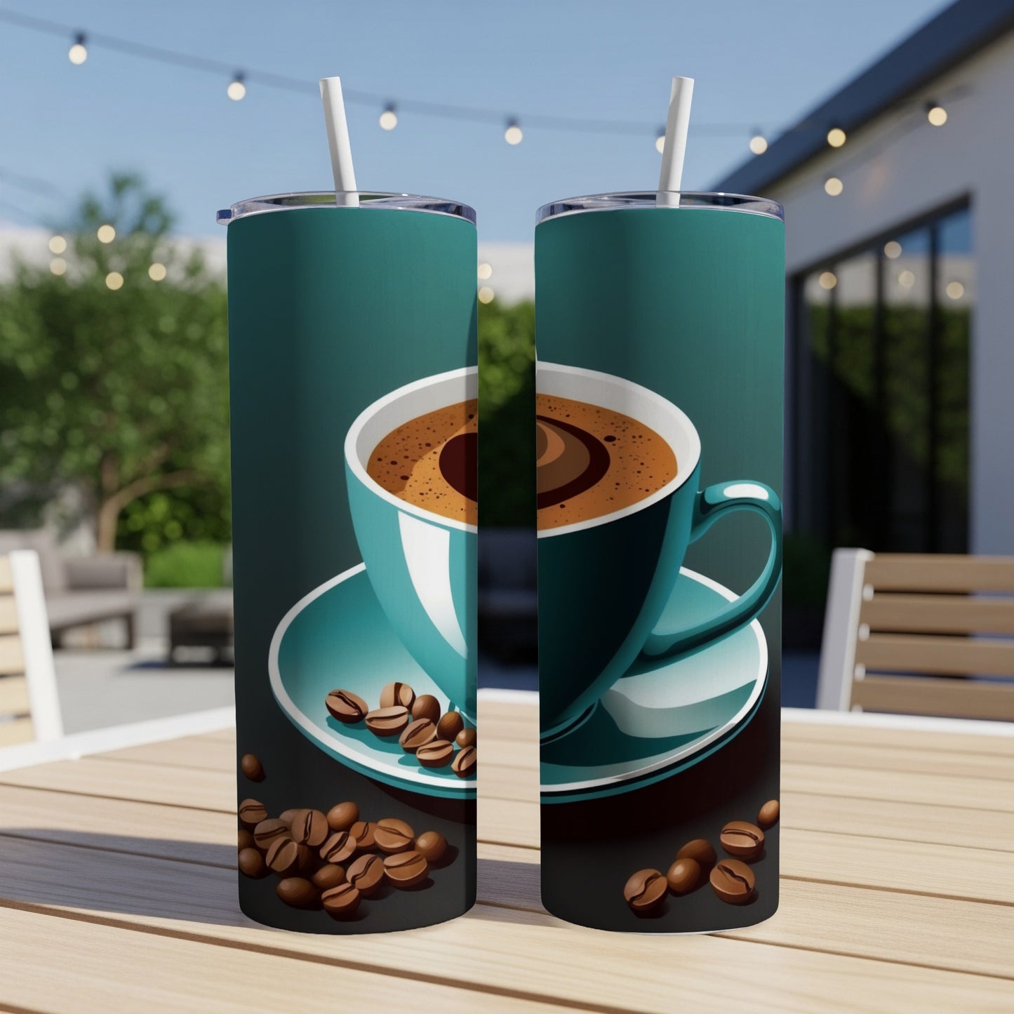 Two teal tumblers with coffee cup and beans design on outdoor table.