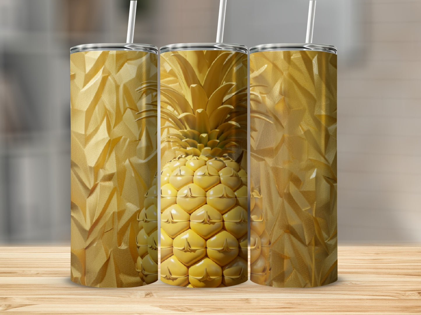Three gold tumblers with pineapple and textured patterns.
