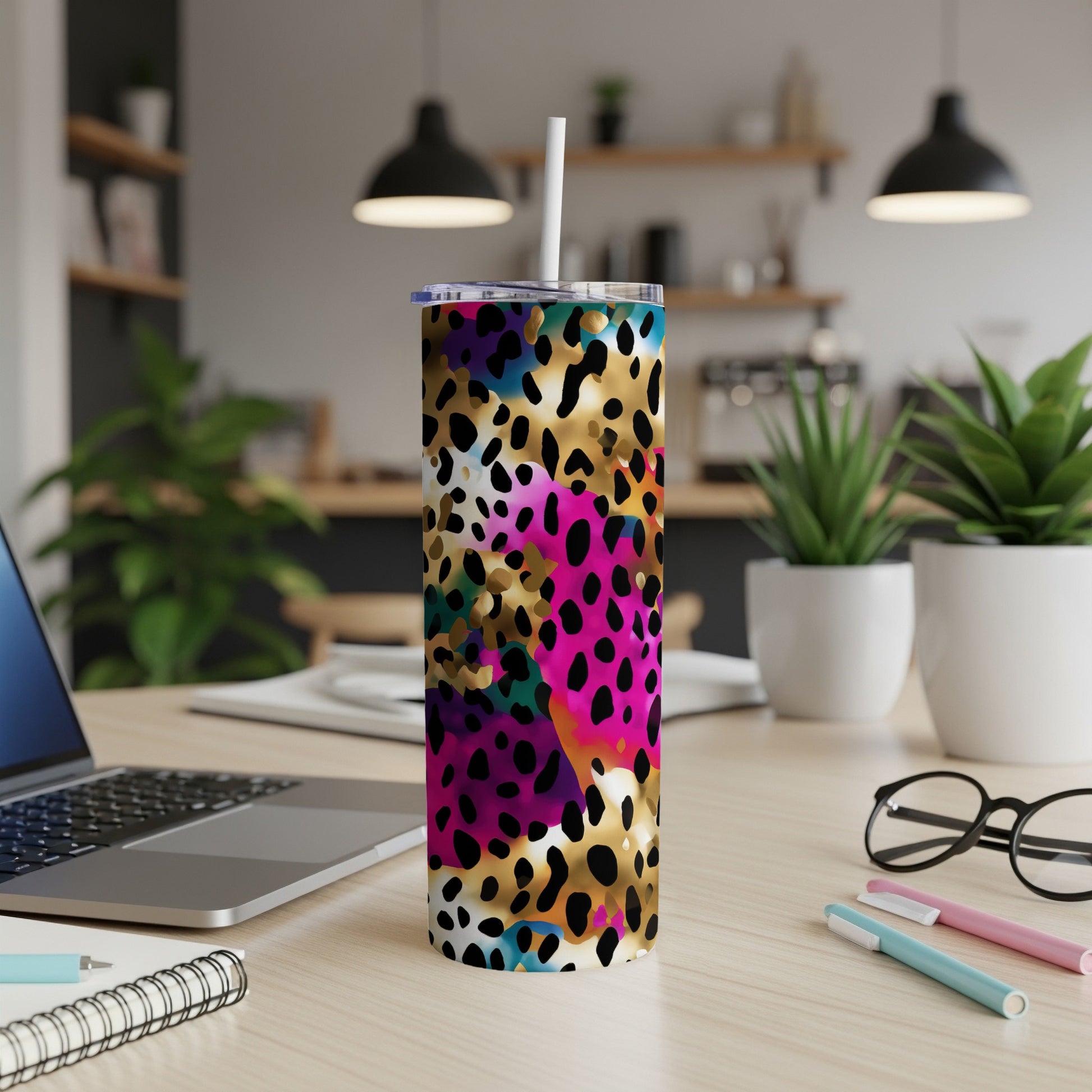 Leopard print tumbler with colorful abstract accents and white straw.