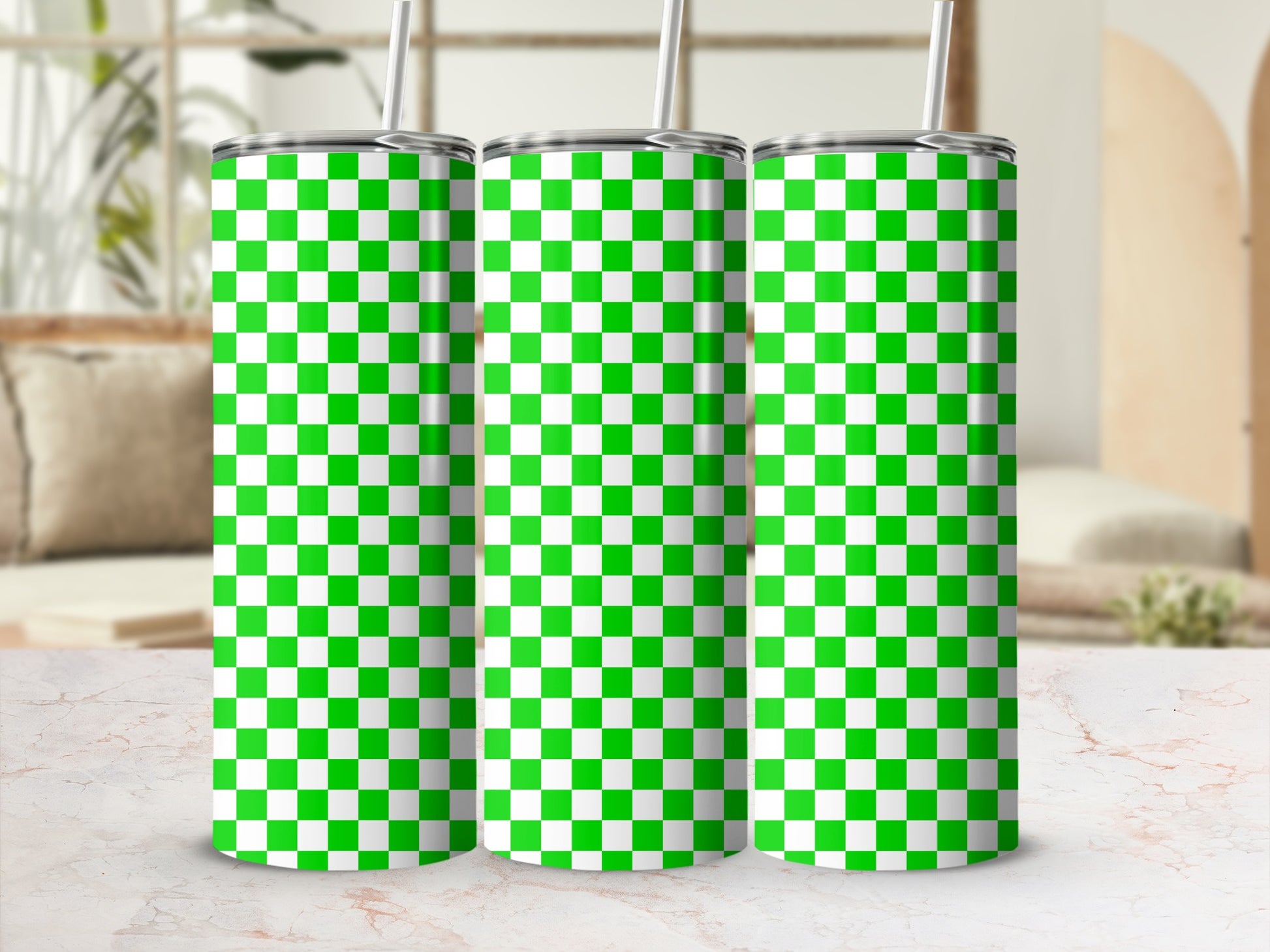 Three green and white checkered tumblers with straws.