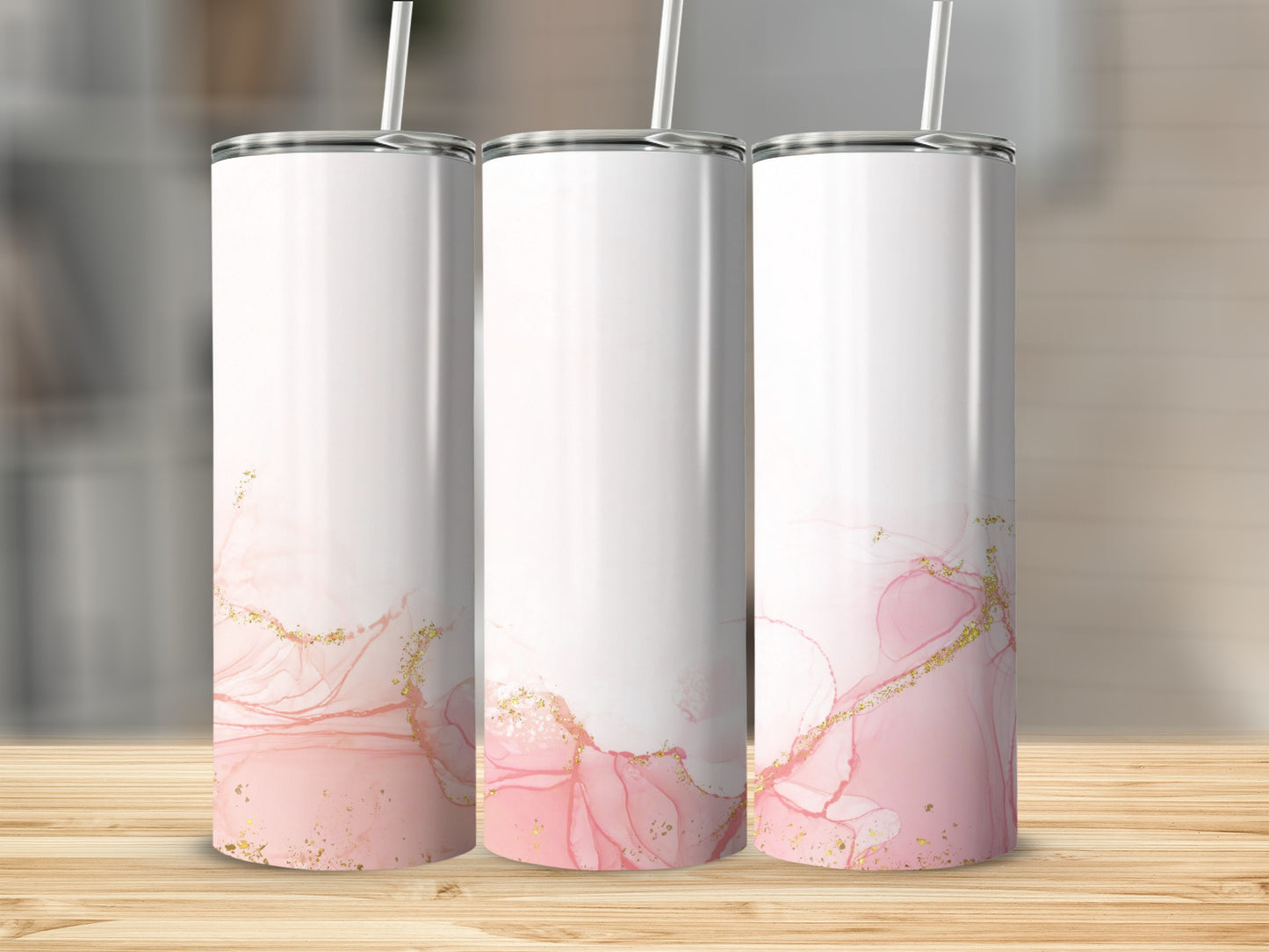 Three tumblers with pink and gold marble design and white lids.
