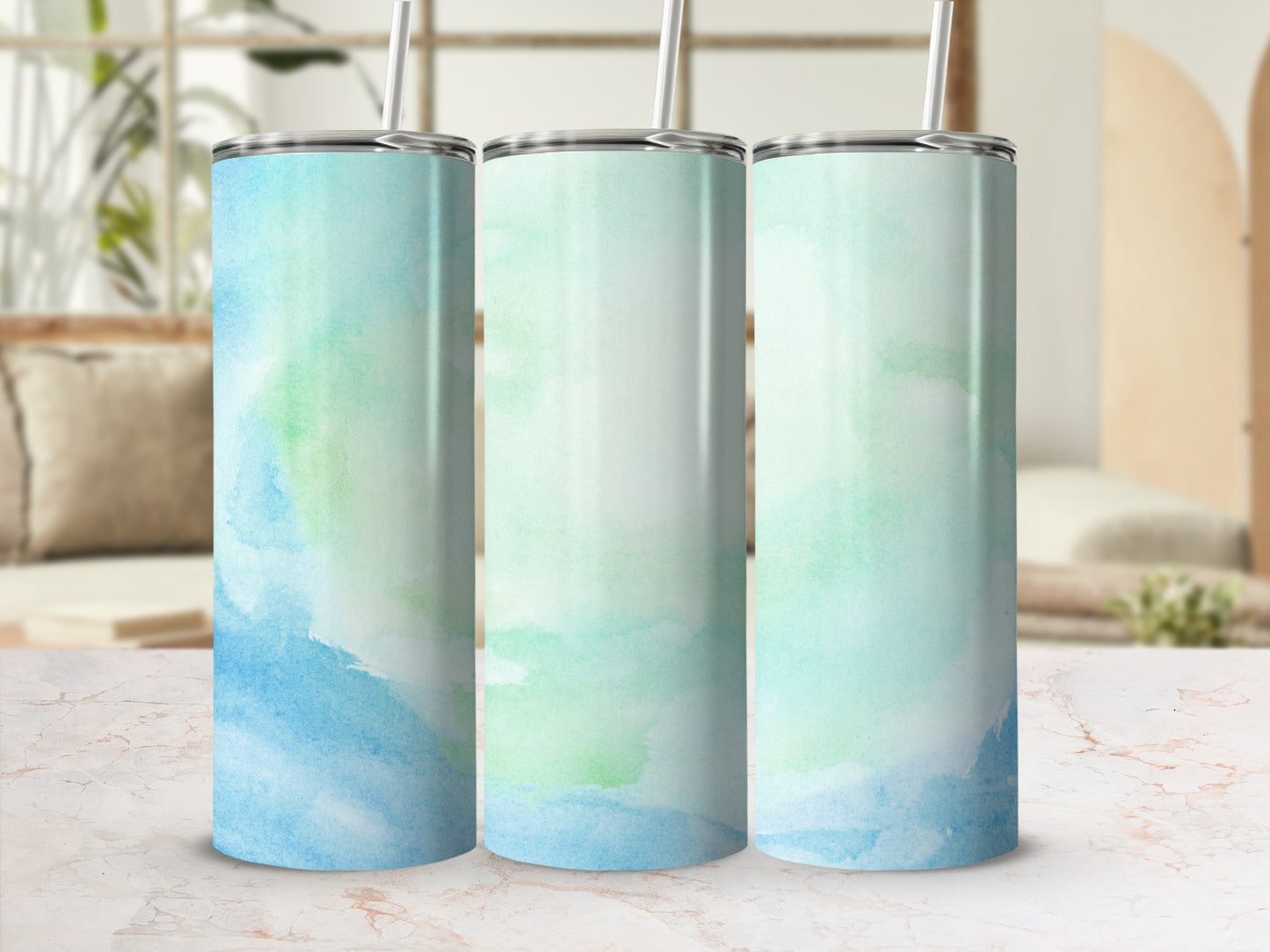 Three tumblers with watercolor blue and green abstract designs.