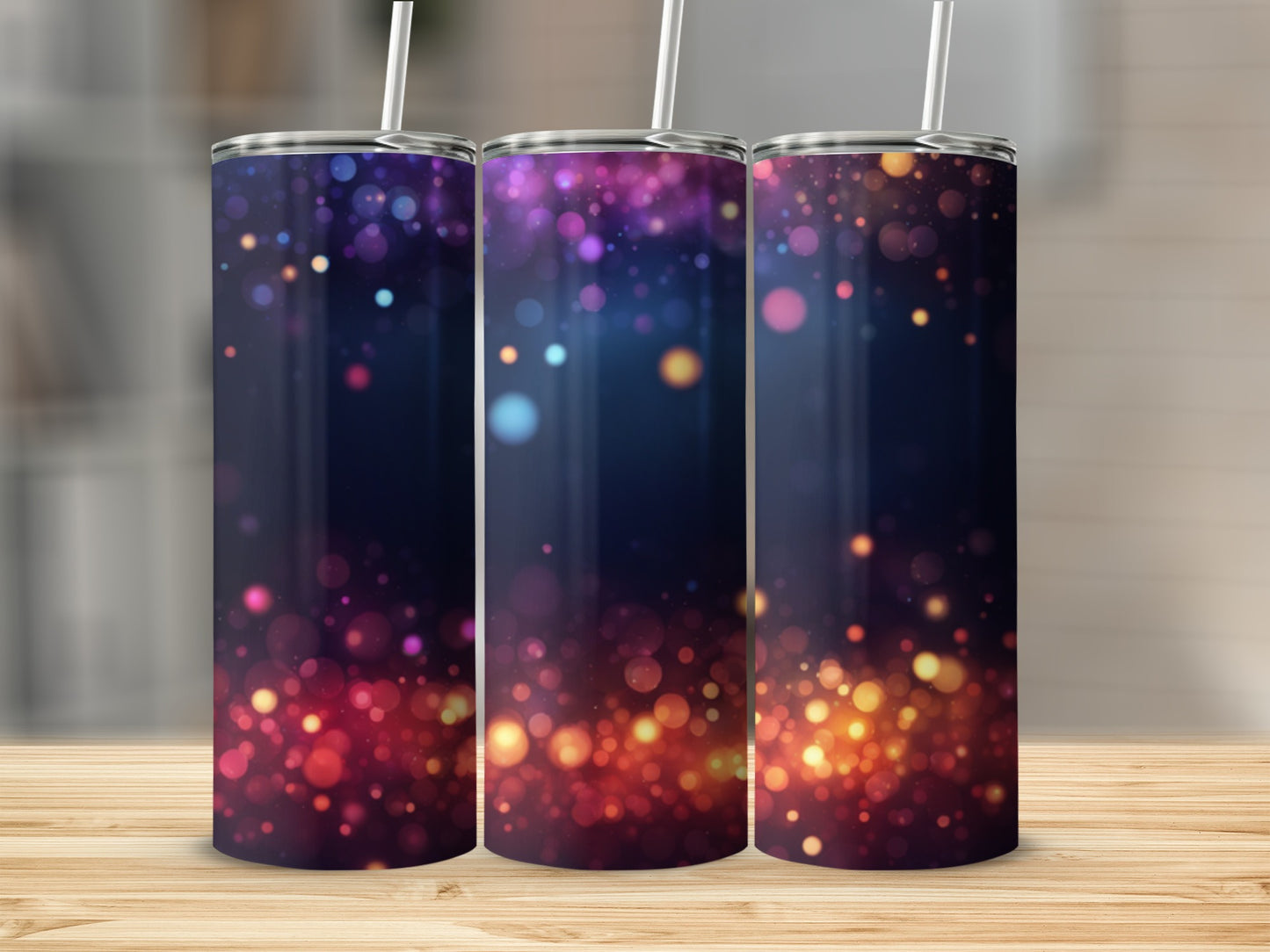 Three tumblers with a bokeh glitter design on a wooden surface.