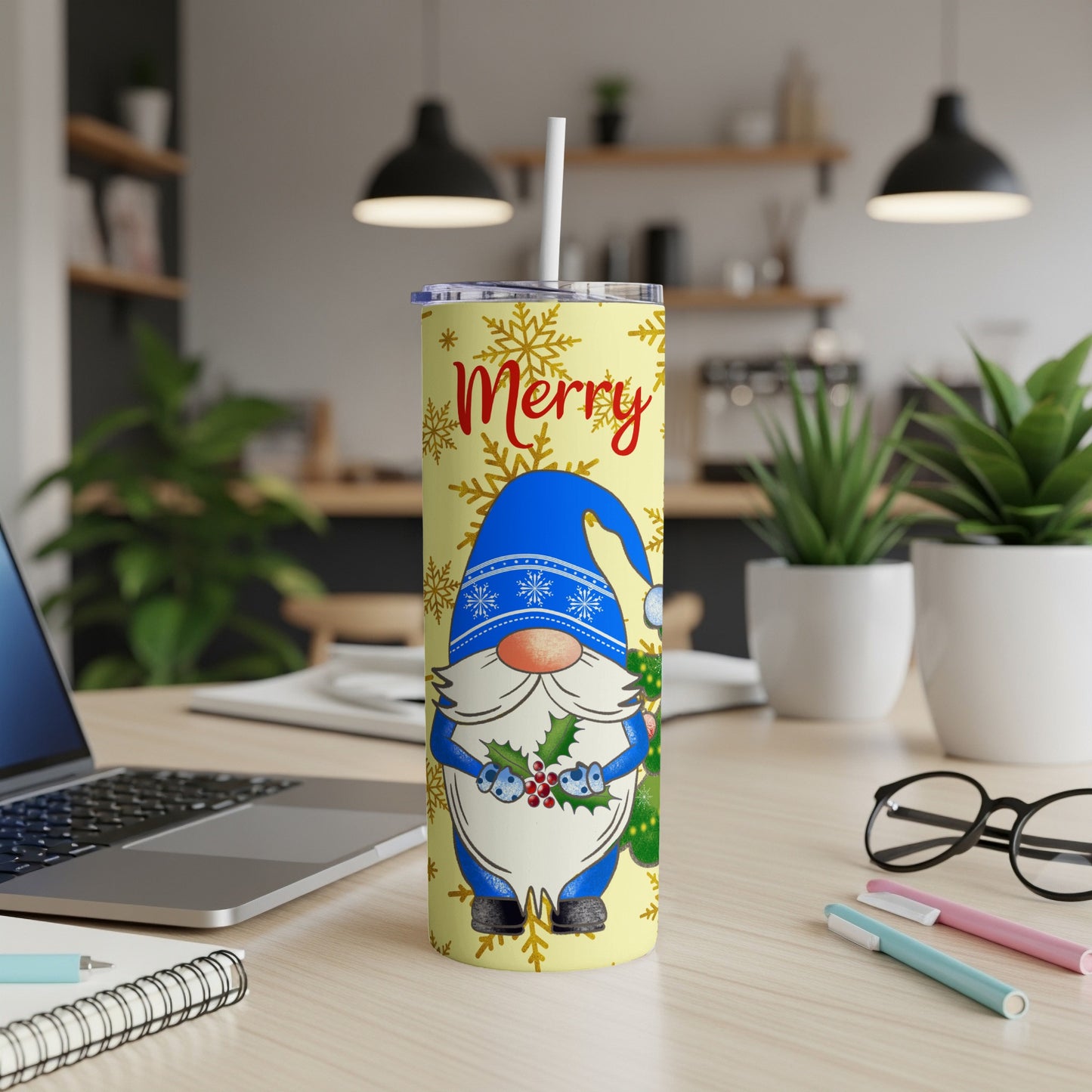 Blue gnome with snowflakes and "Merry" text on a yellow tumbler.