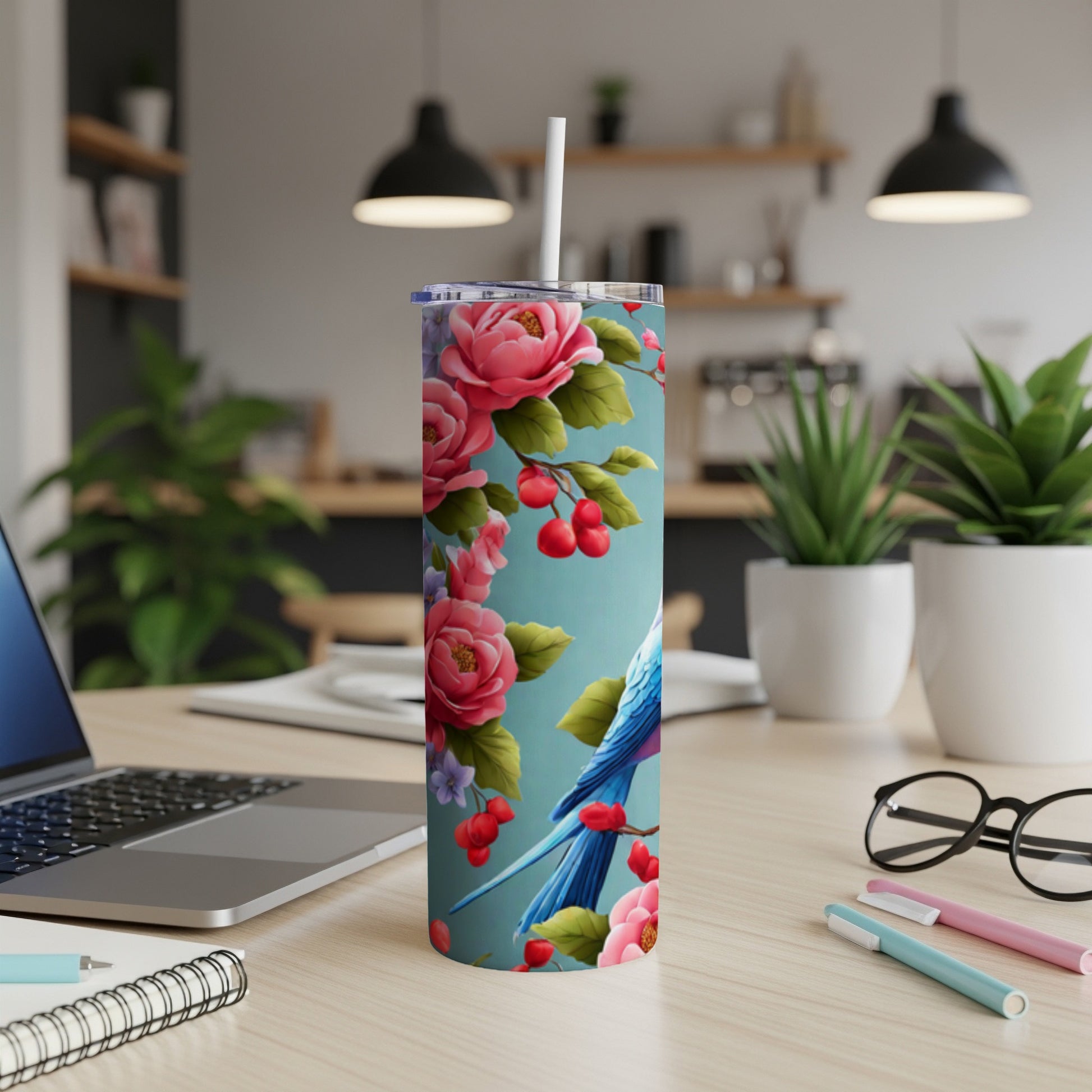 Blue bird and pink flowers on a teal skinny tumbler with straw.