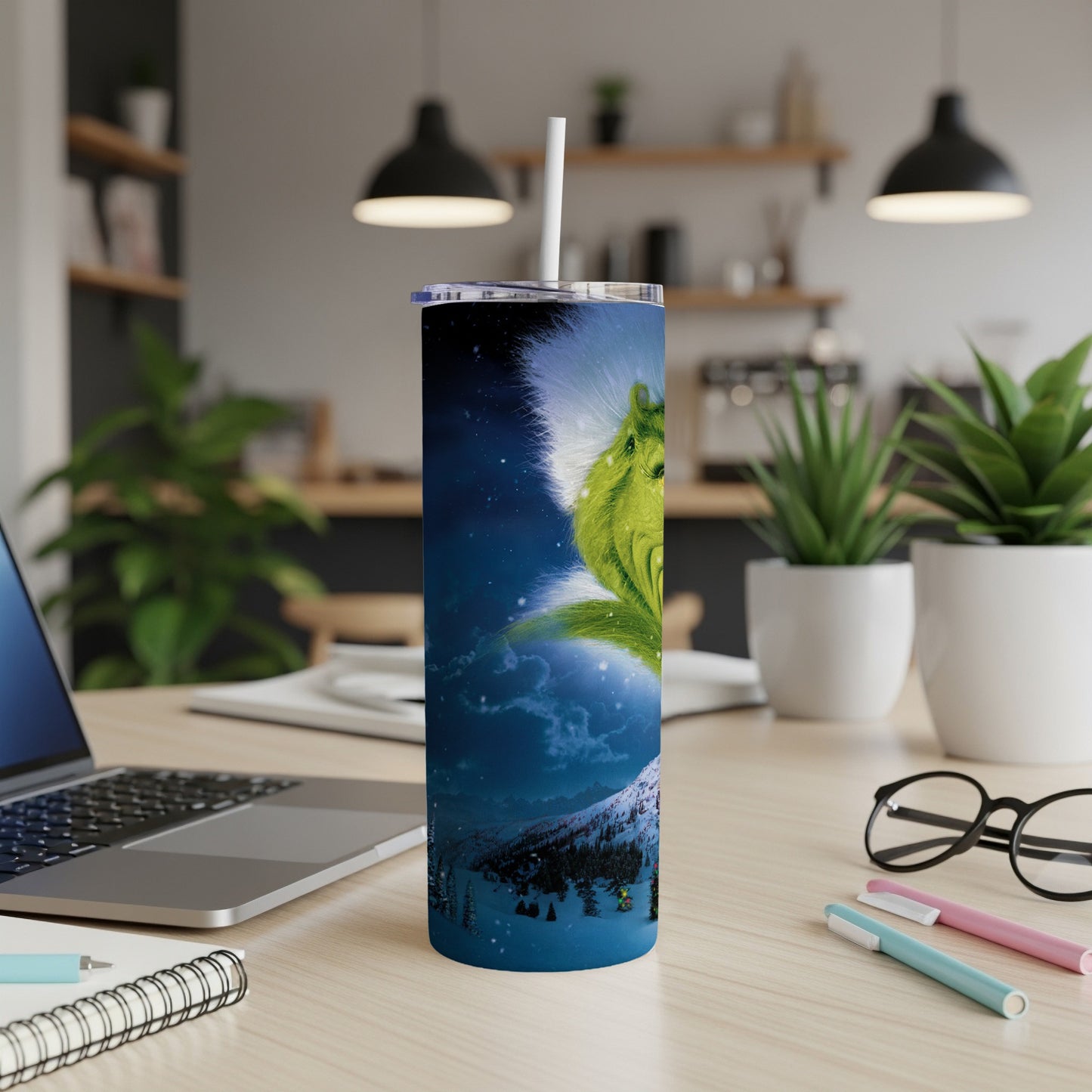 Grinch artwork on a stainless steel tumbler with a straw.