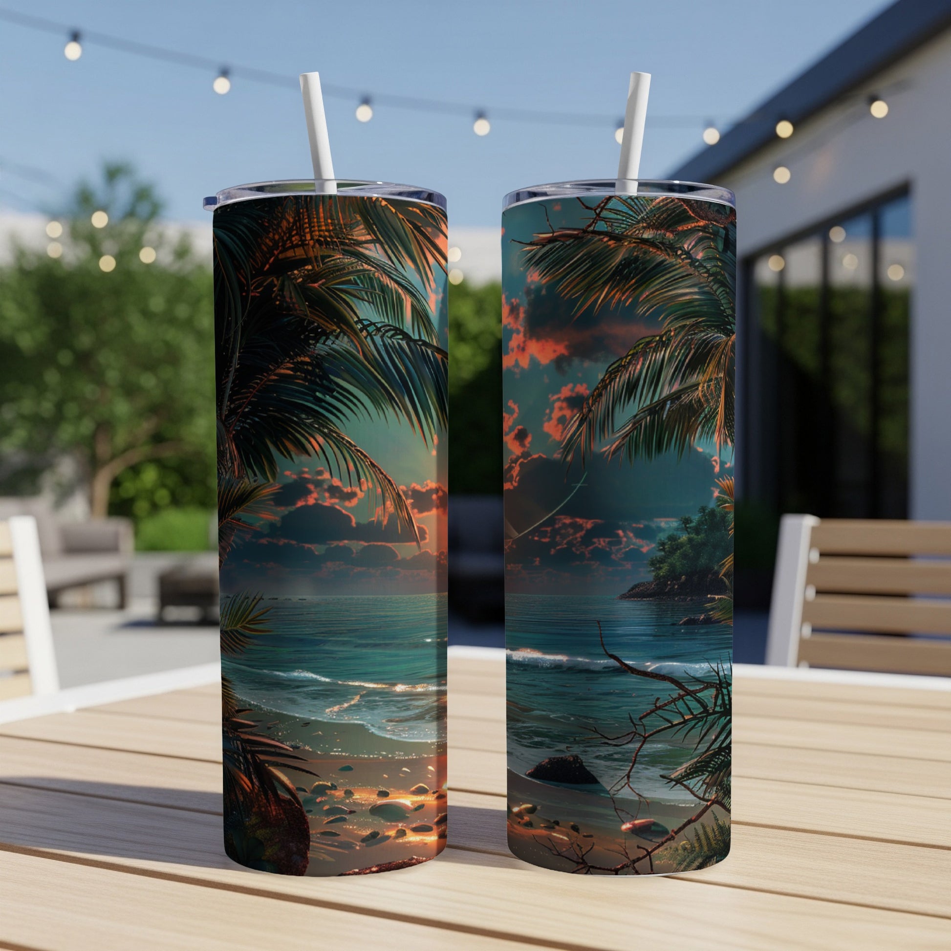 Two tall tumblers with a tropical beach sunset design sit on a wooden table.