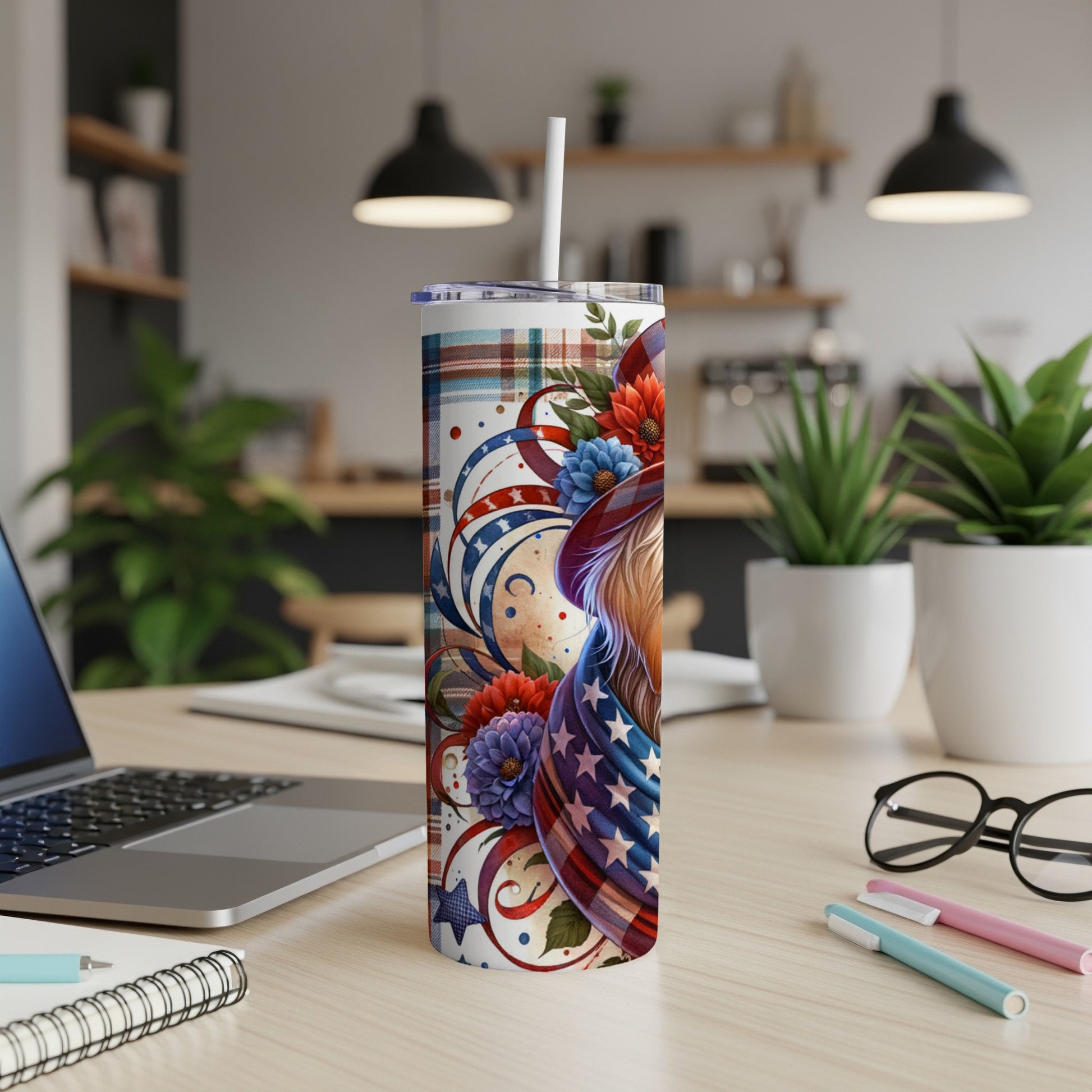 Patriotic tumbler with USA flag stars and flowers, on desk.