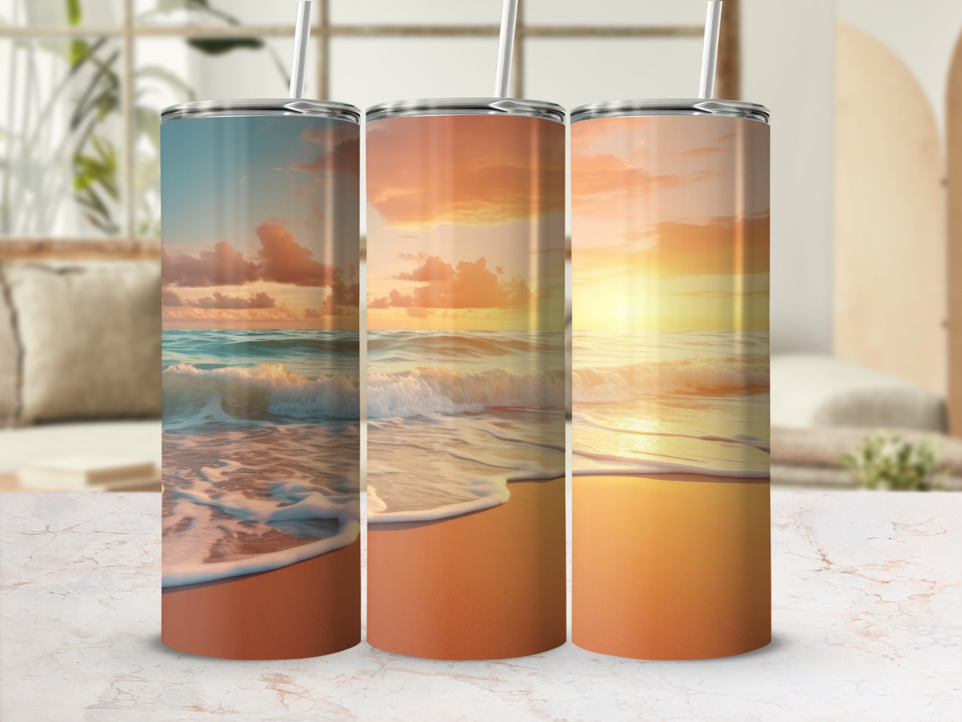 Three tumblers with sunset beach scene graphics, straws inserted.