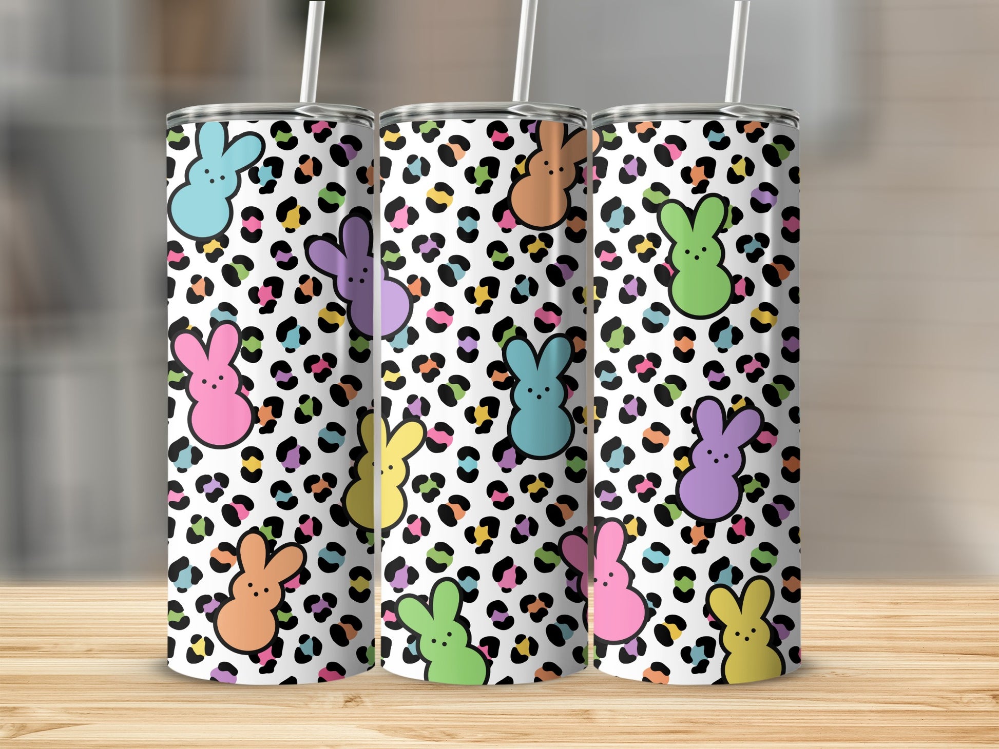 Leopard print tumbler with colorful bunny ears and faces.