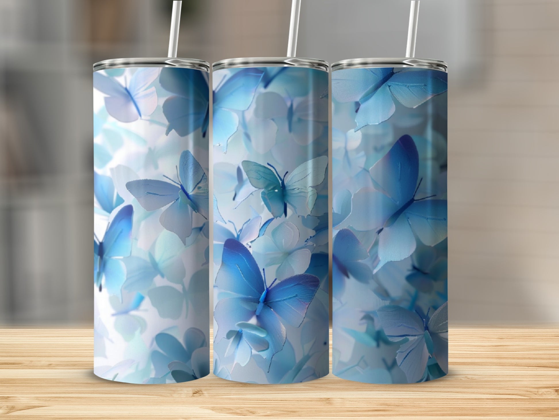 Three tumblers featuring a pattern of soft blue butterflies and flowers.