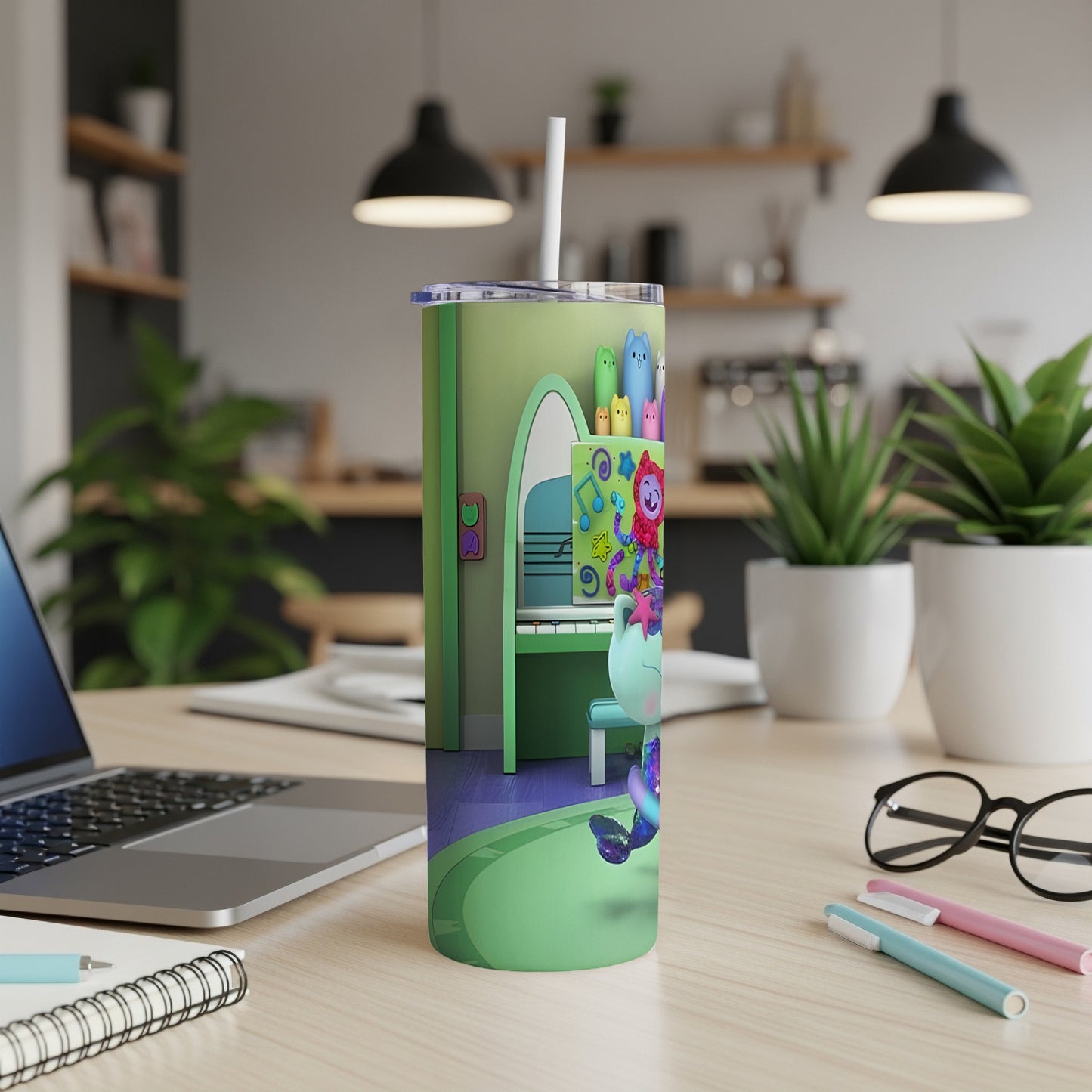 Green tumbler with cartoon cat and colorful musical notes.