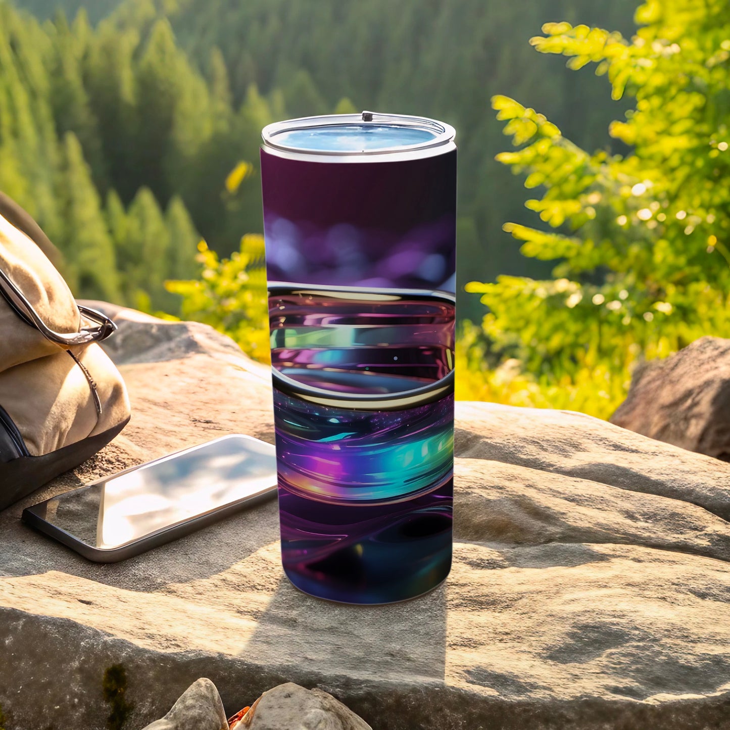 Tumbler with abstract purple and blue swirling design outdoors.