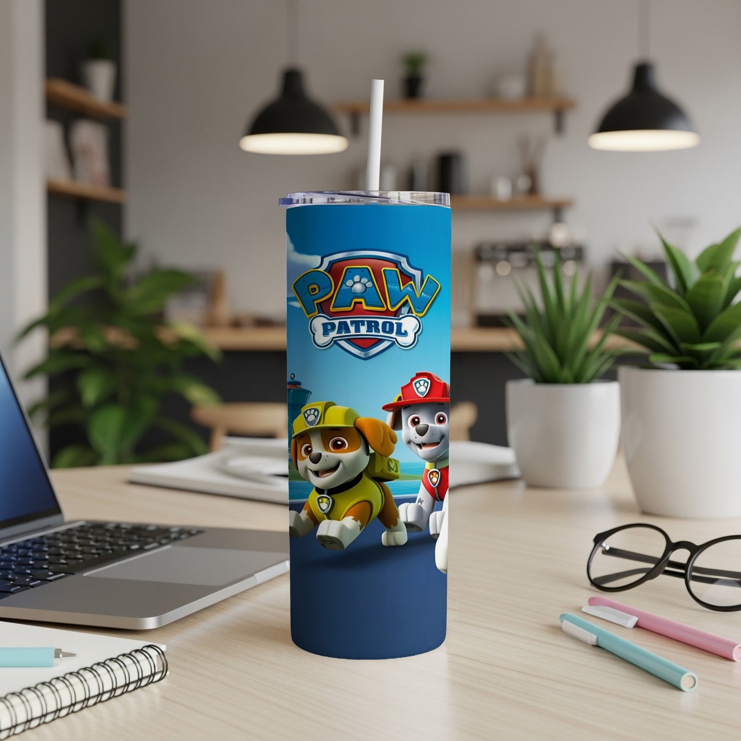 Paw Patrol characters Chase and Marshall on a blue tumbler with a white straw.