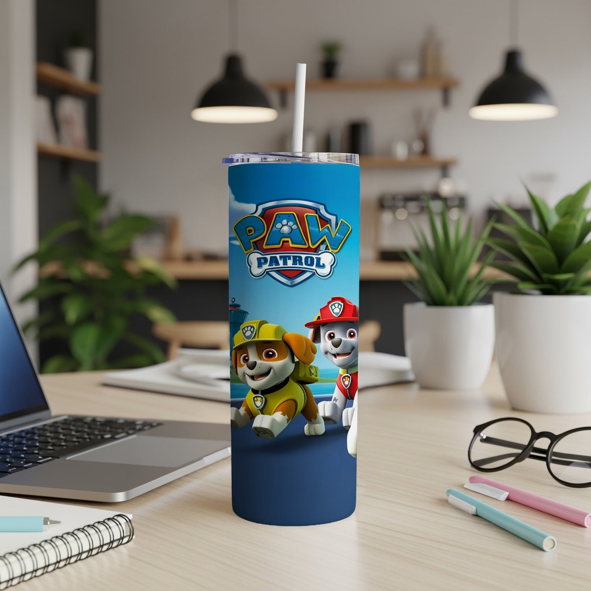 Paw Patrol characters Chase and Marshall on a blue tumbler with a white straw.