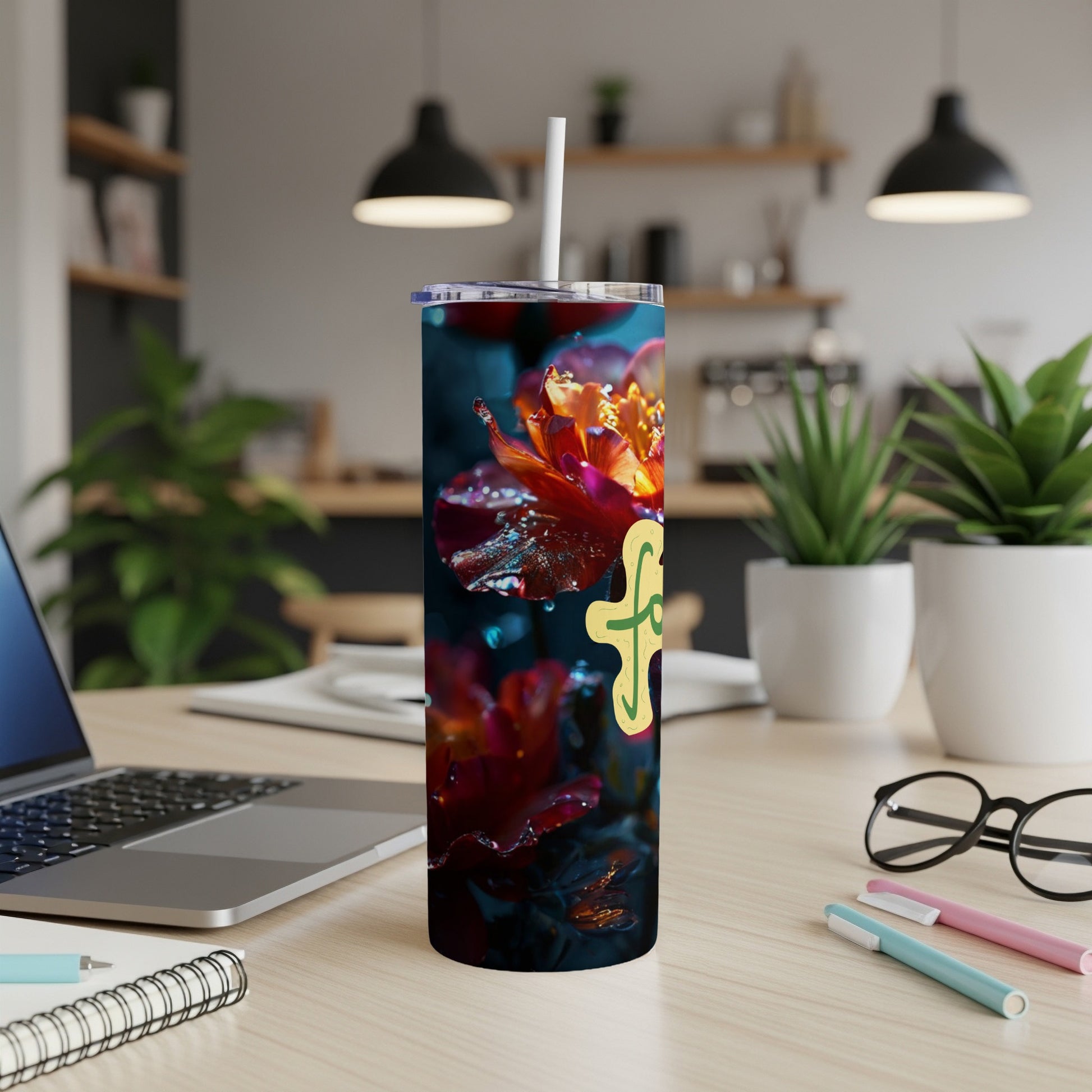 Tumbler with yellow floral design and water droplets on dark background.
