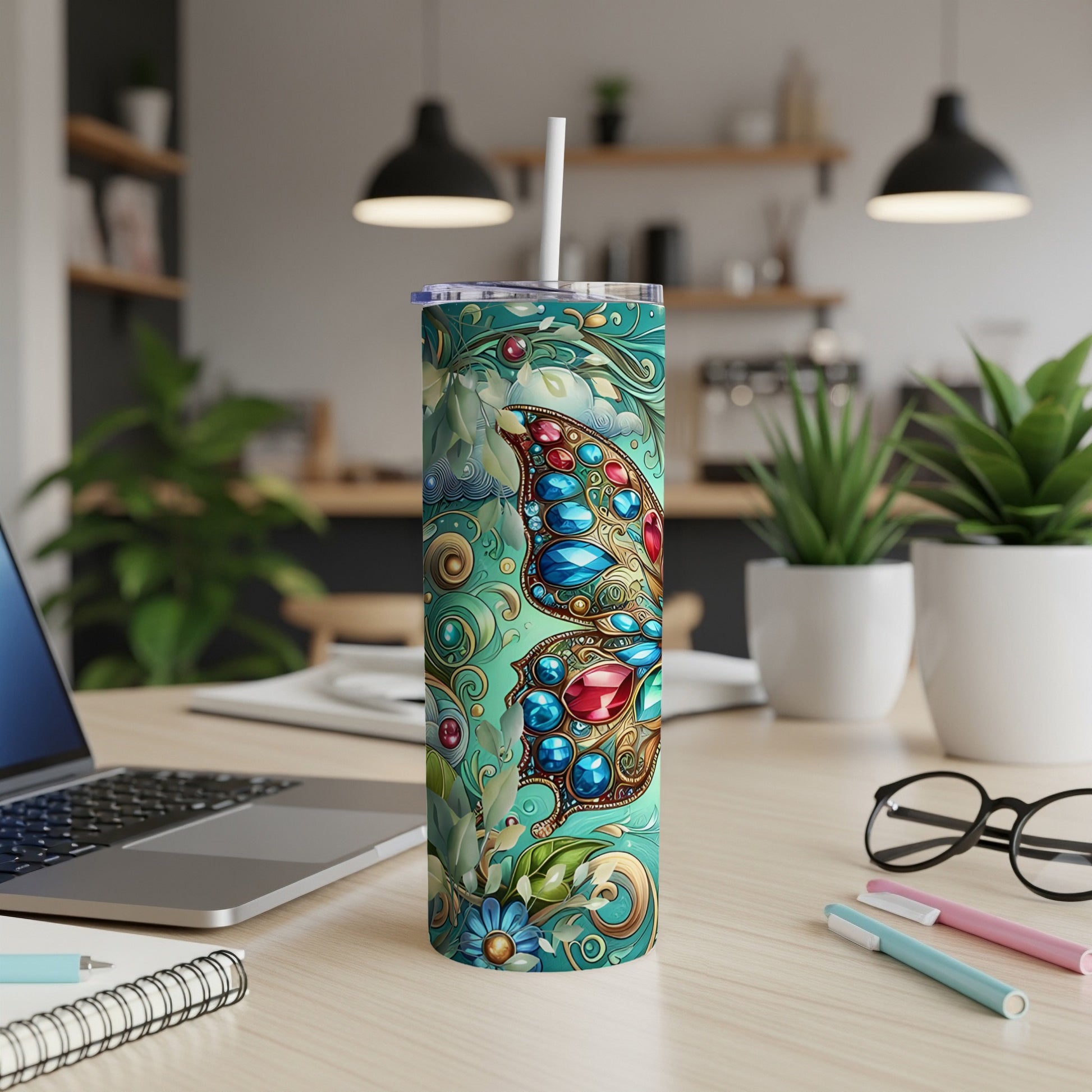 Turquoise tumbler with ornate butterfly and jewel design.