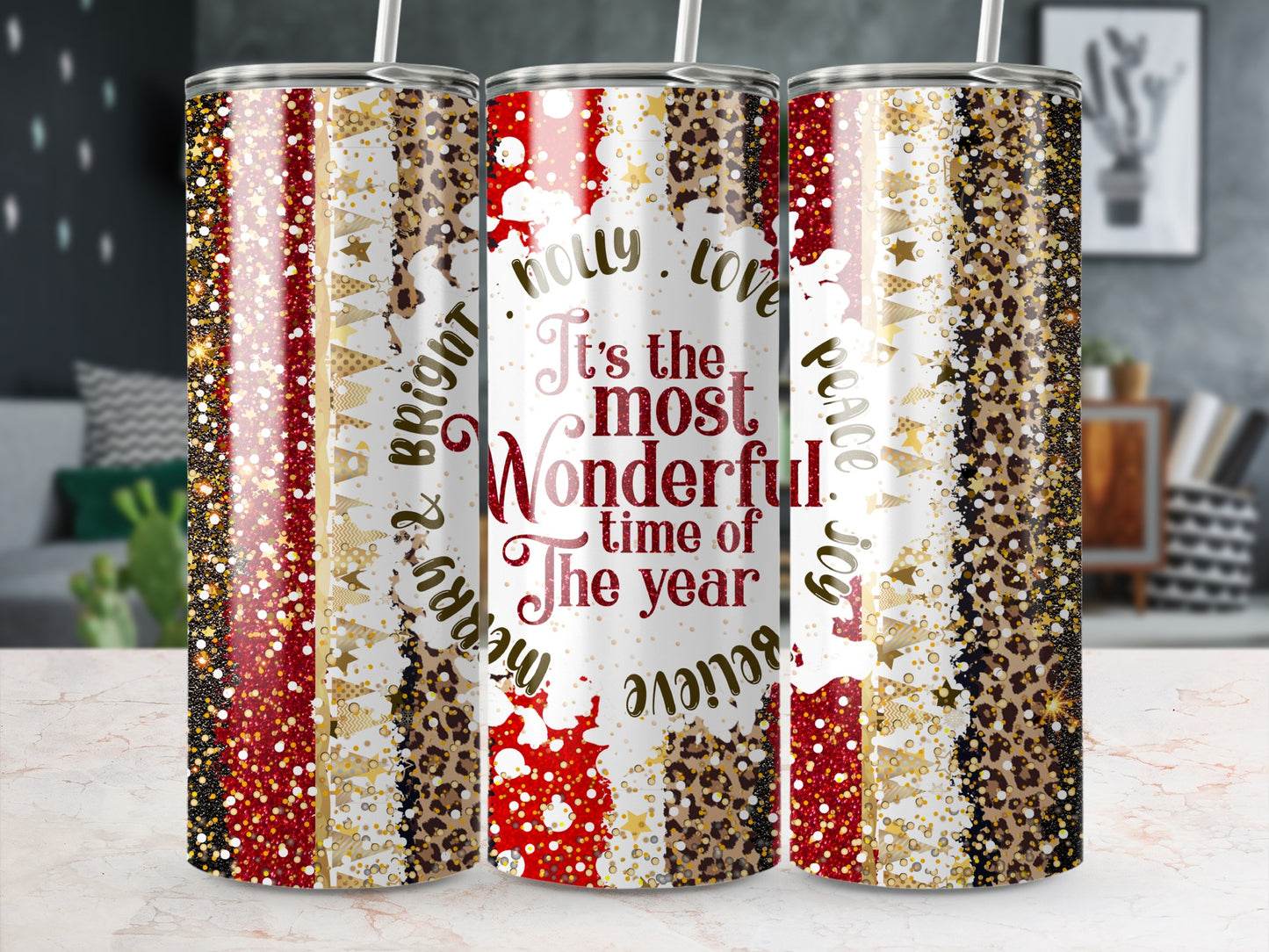Three tumblers with "It's the most wonderful time of the year" and holiday patterns.