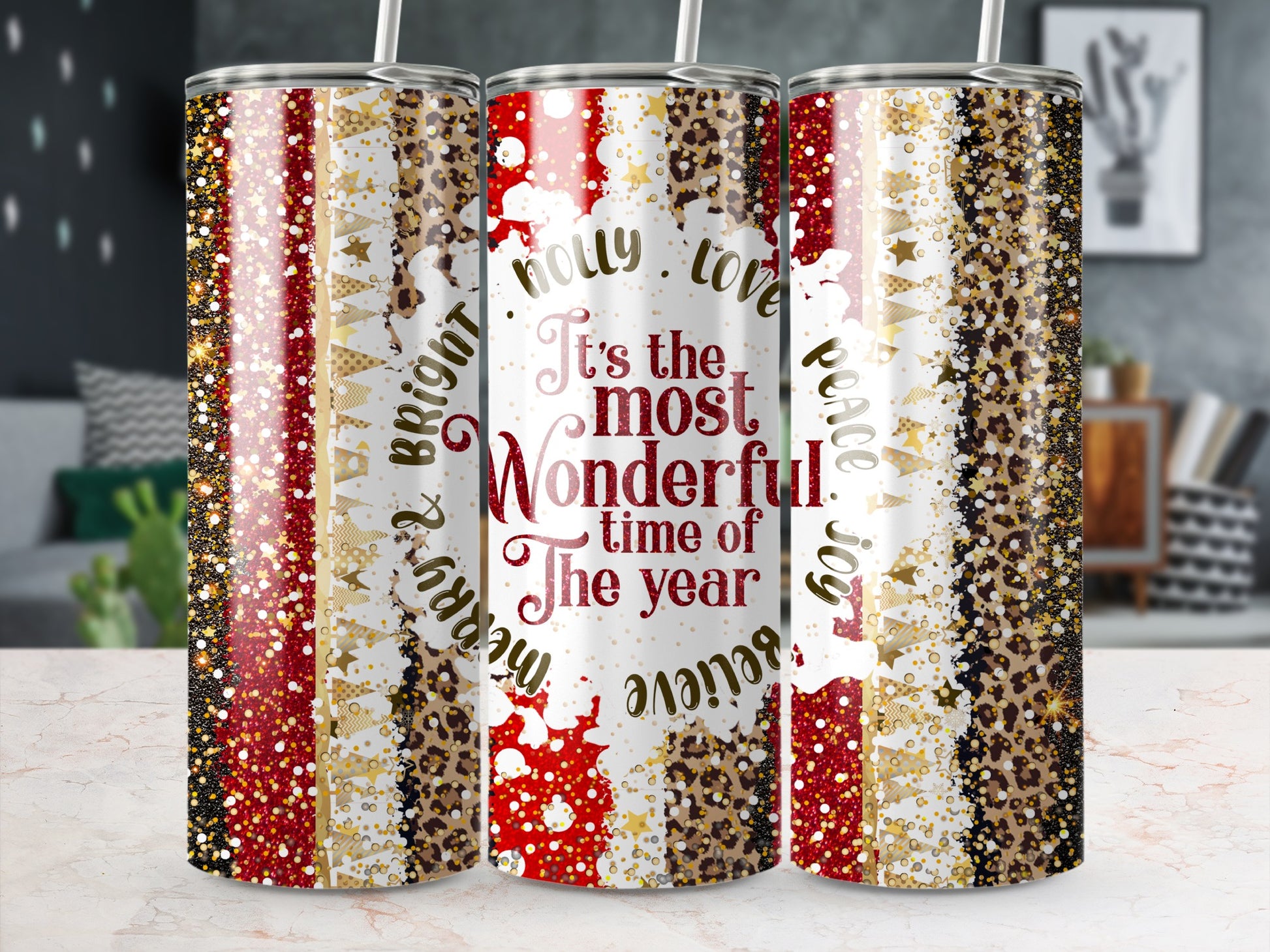 Three tumblers with "It's the most wonderful time of the year" and holiday patterns.
