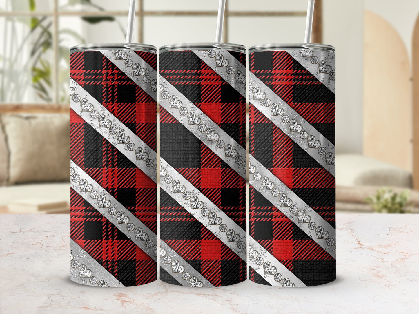 Three plaid tumblers with rhinestone heart accents on a counter.