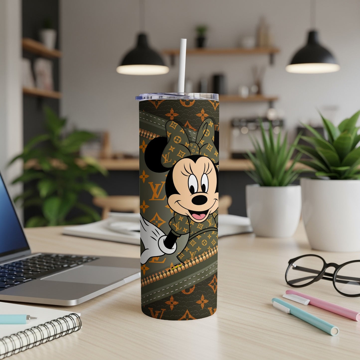 Minnie Mouse on a Louis Vuitton pattern tumbler with a straw.