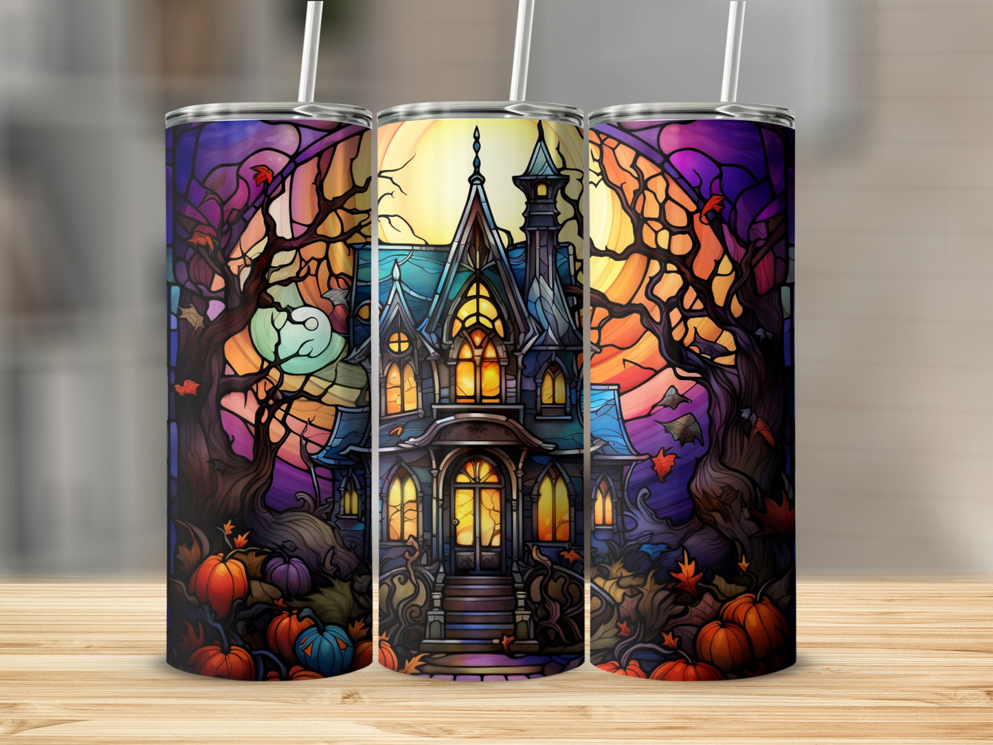 Haunted house and pumpkins on a Halloween tumbler.