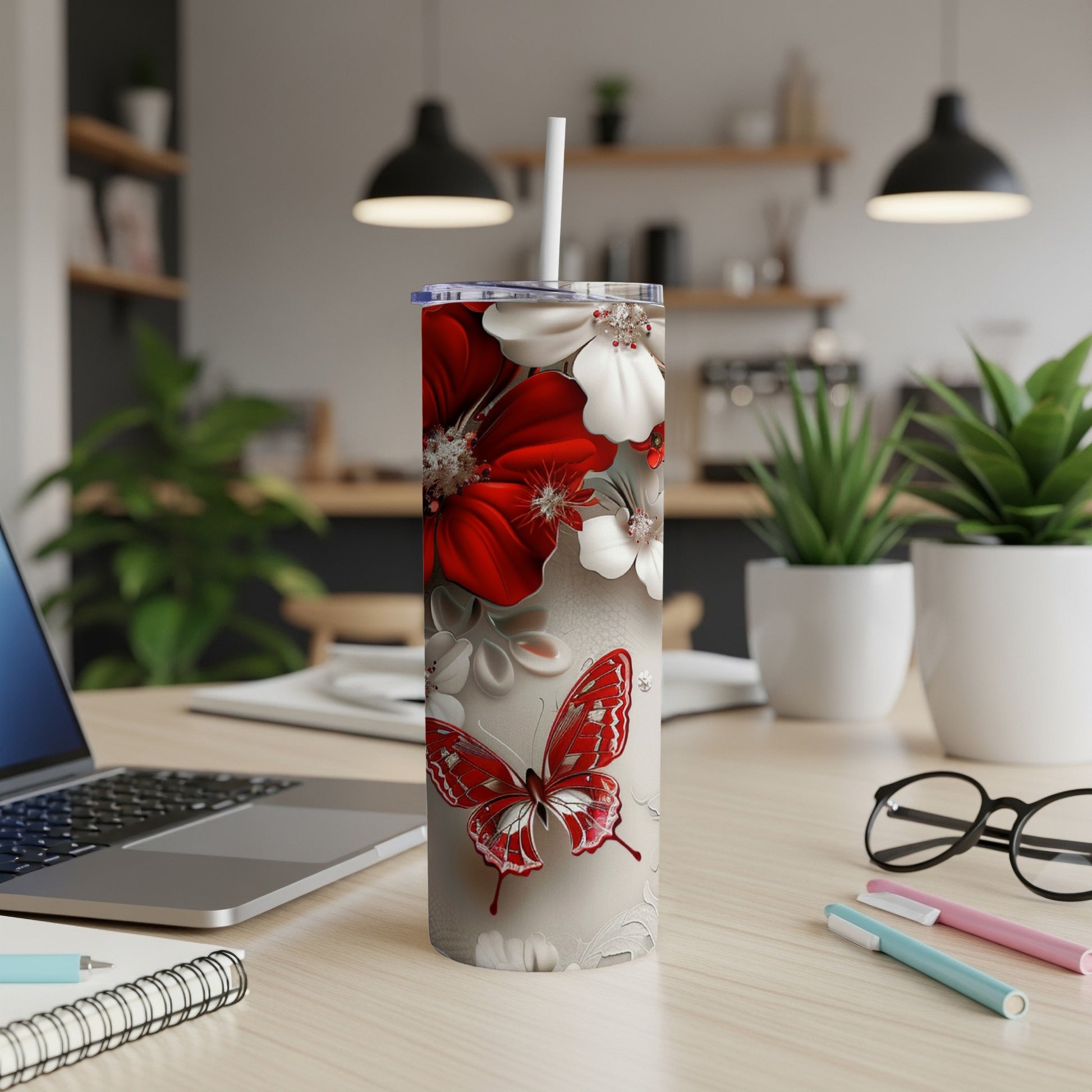 Silver tumbler with red and white flowers and a butterfly design.