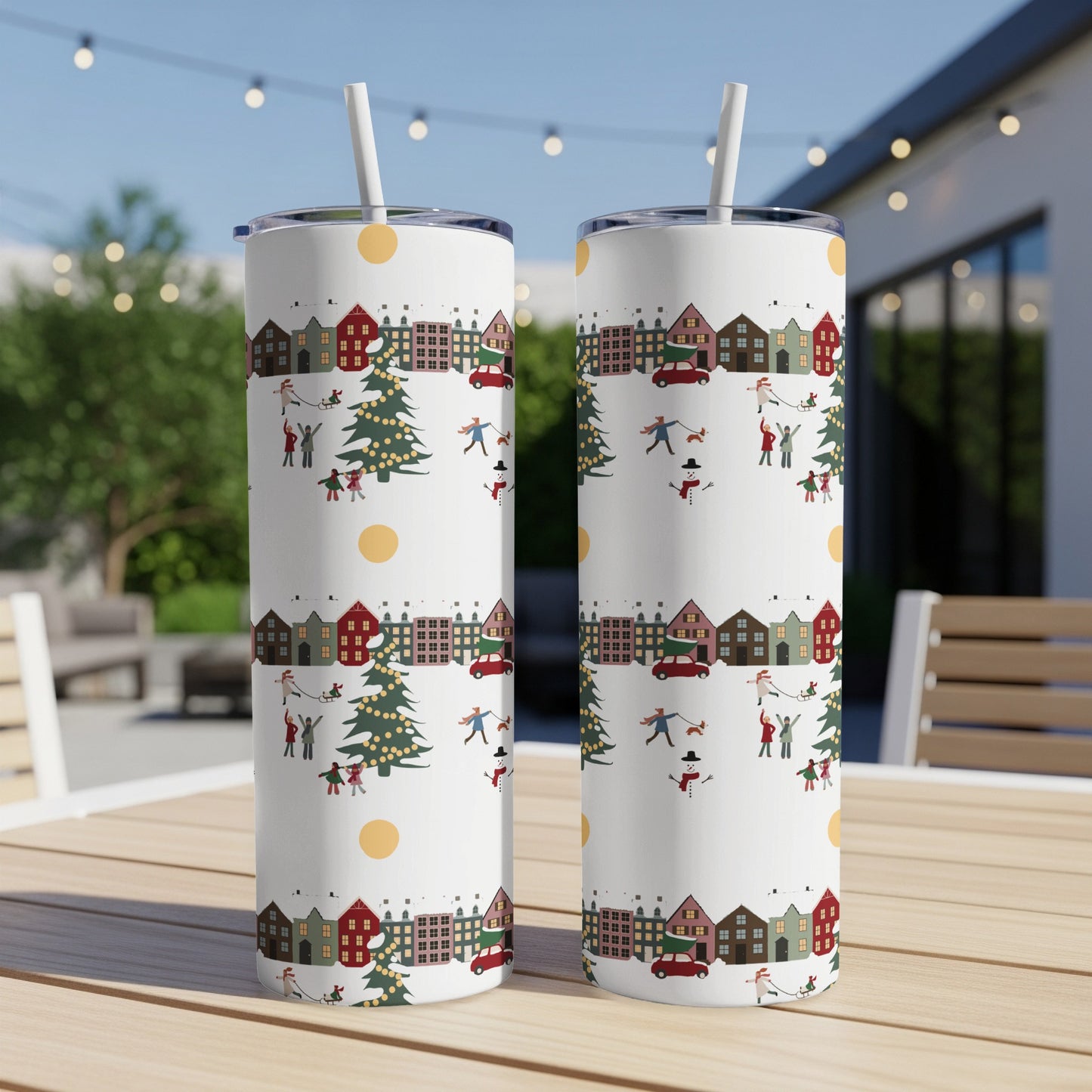 White tumbler with a repeating Christmas village pattern of houses, trees, and snowmen.