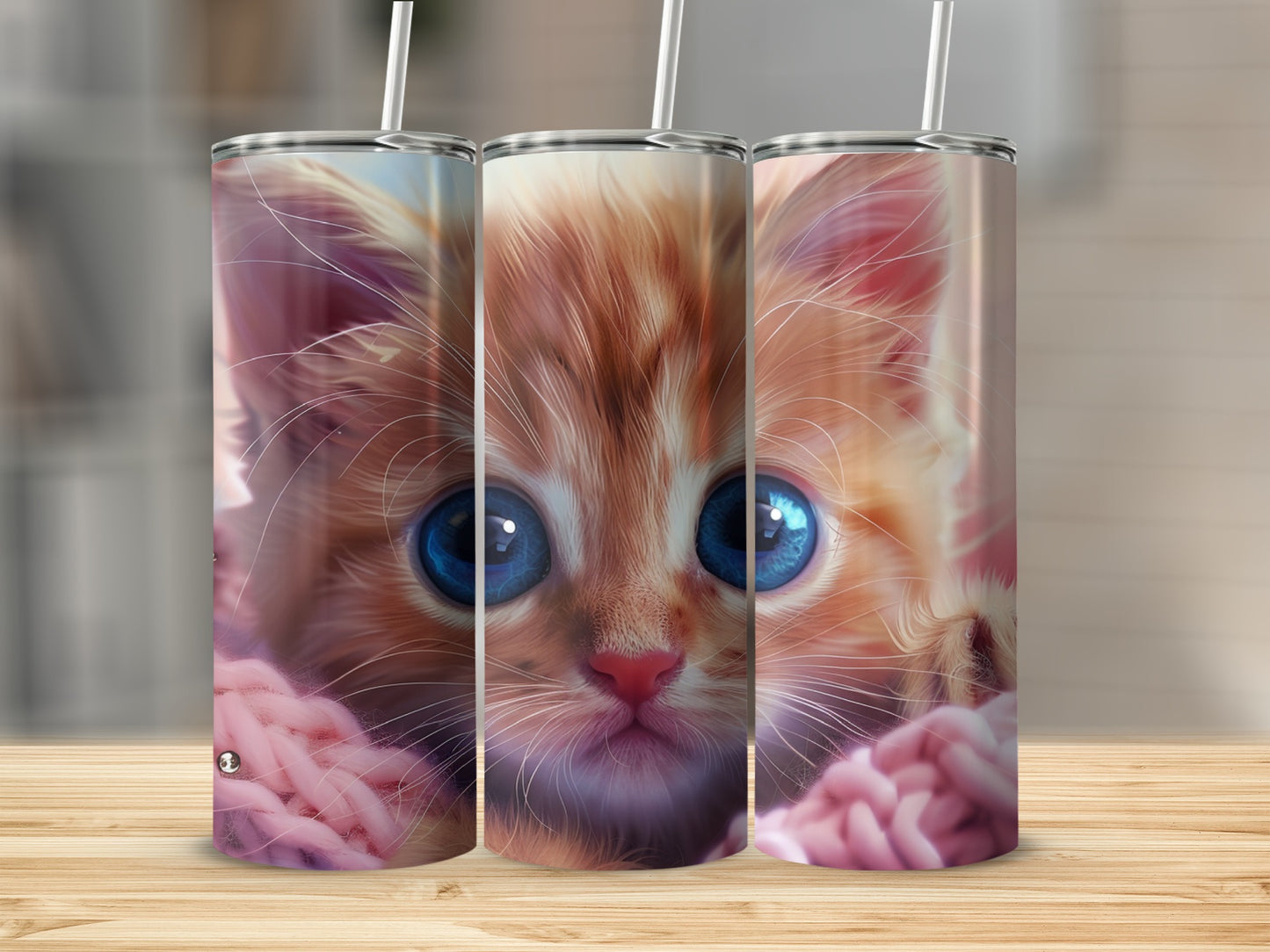 Close-up of a fluffy orange kitten with large blue eyes, wrapped in pink yarn.