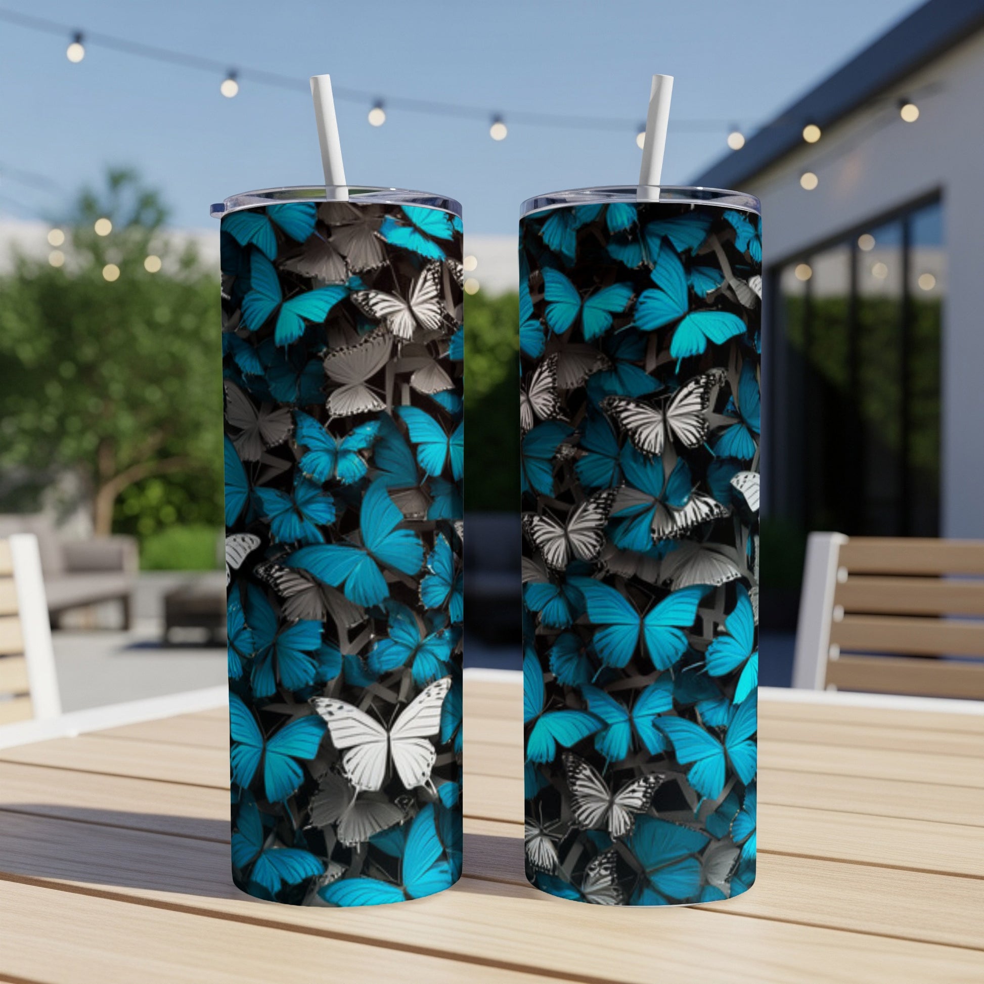 Two blue and white butterfly patterned tumblers on a wooden table.