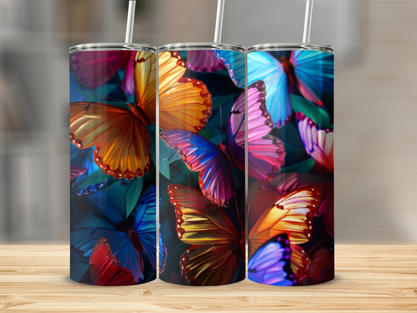 Three tumblers featuring vibrant, colorful butterfly patterns.