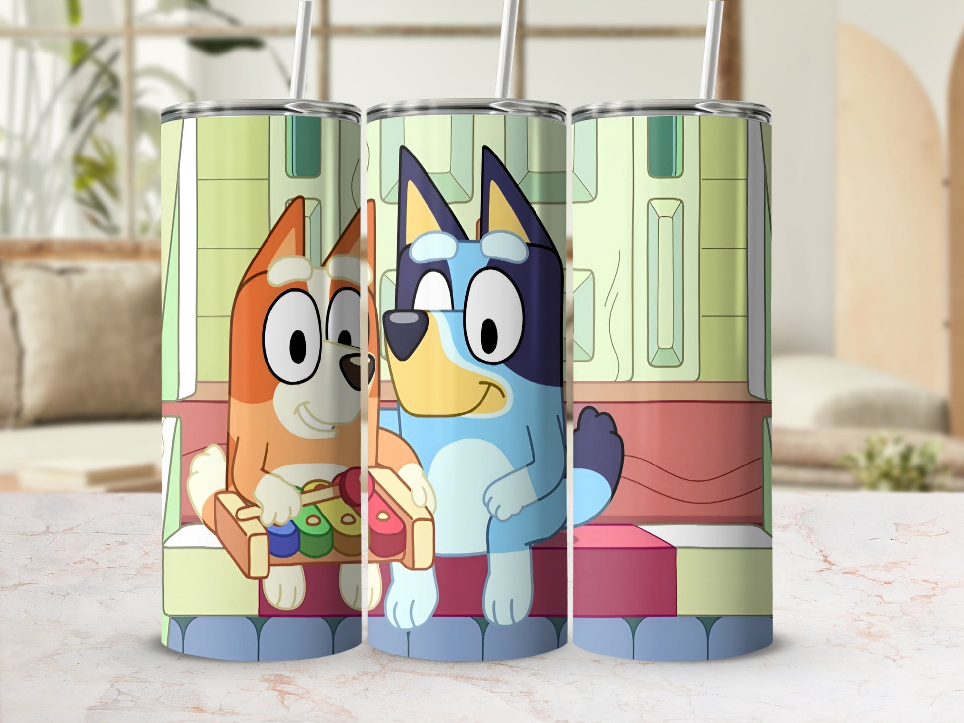 Bluey and Bingo characters on a tumbler with colorful xylophone.
