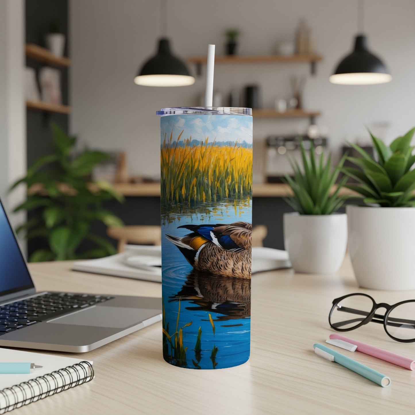 Mallard duck swimming in reeds on a blue water tumbler.