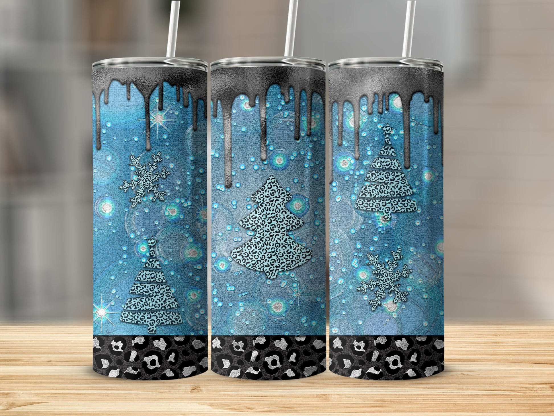 Three blue tumblers with dripping black tops and leopard print bases.