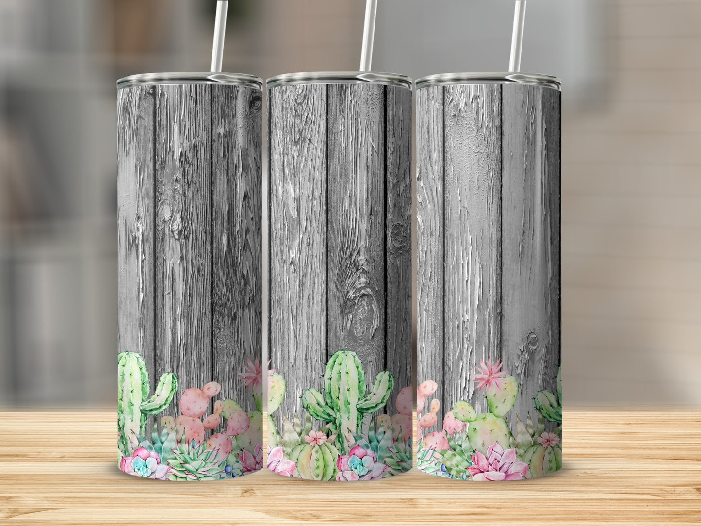 Three tumblers with a rustic wood background and succulent designs.
