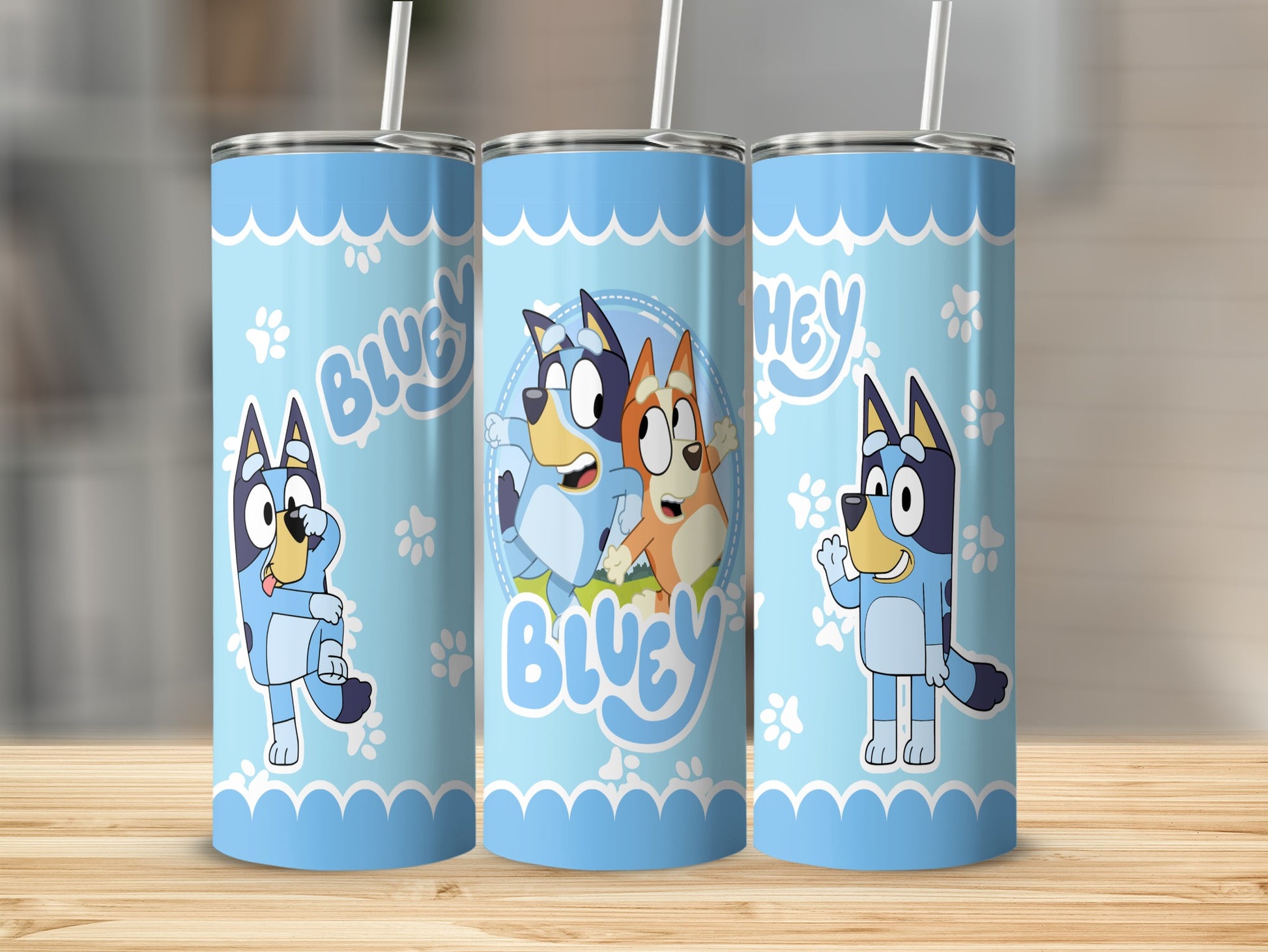Bluey characters on three blue tumblers with white straw.