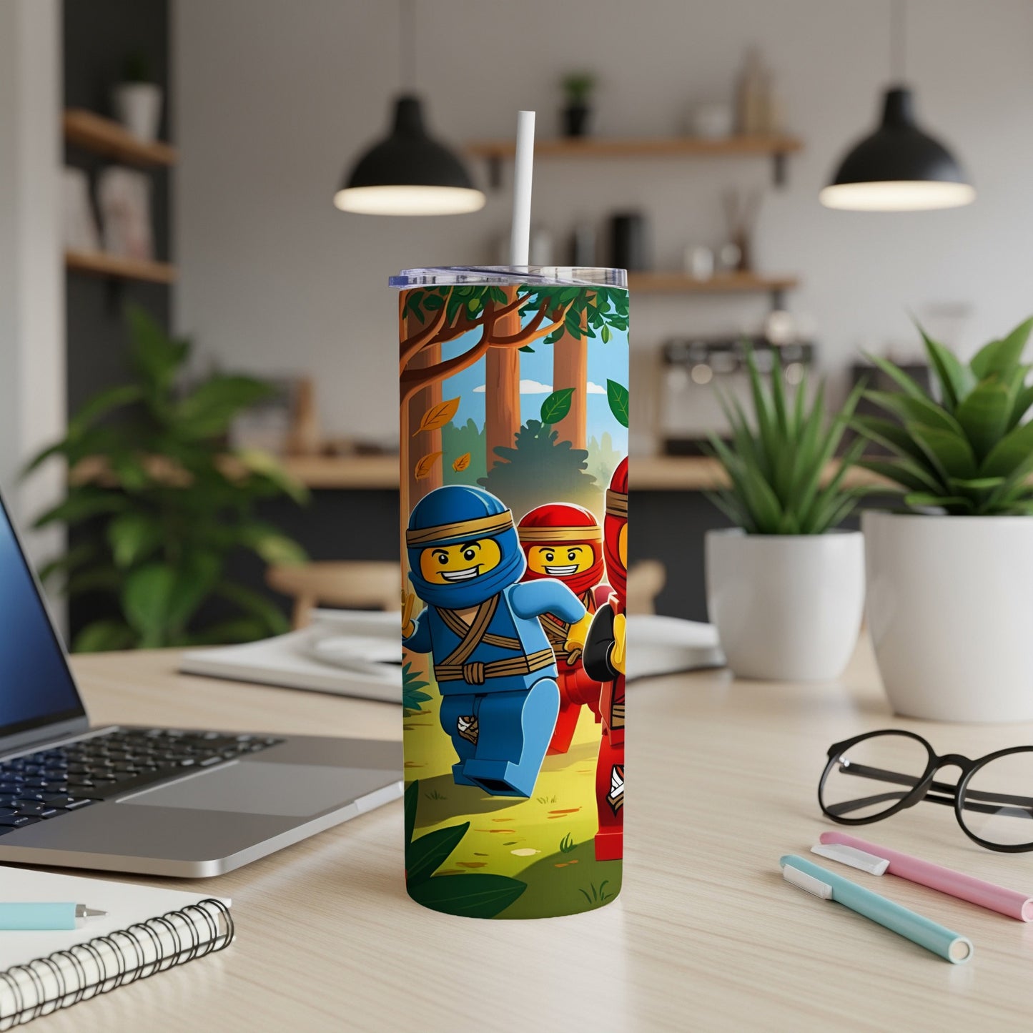 Ninjago characters in a forest setting on a blue tumbler with a white straw.