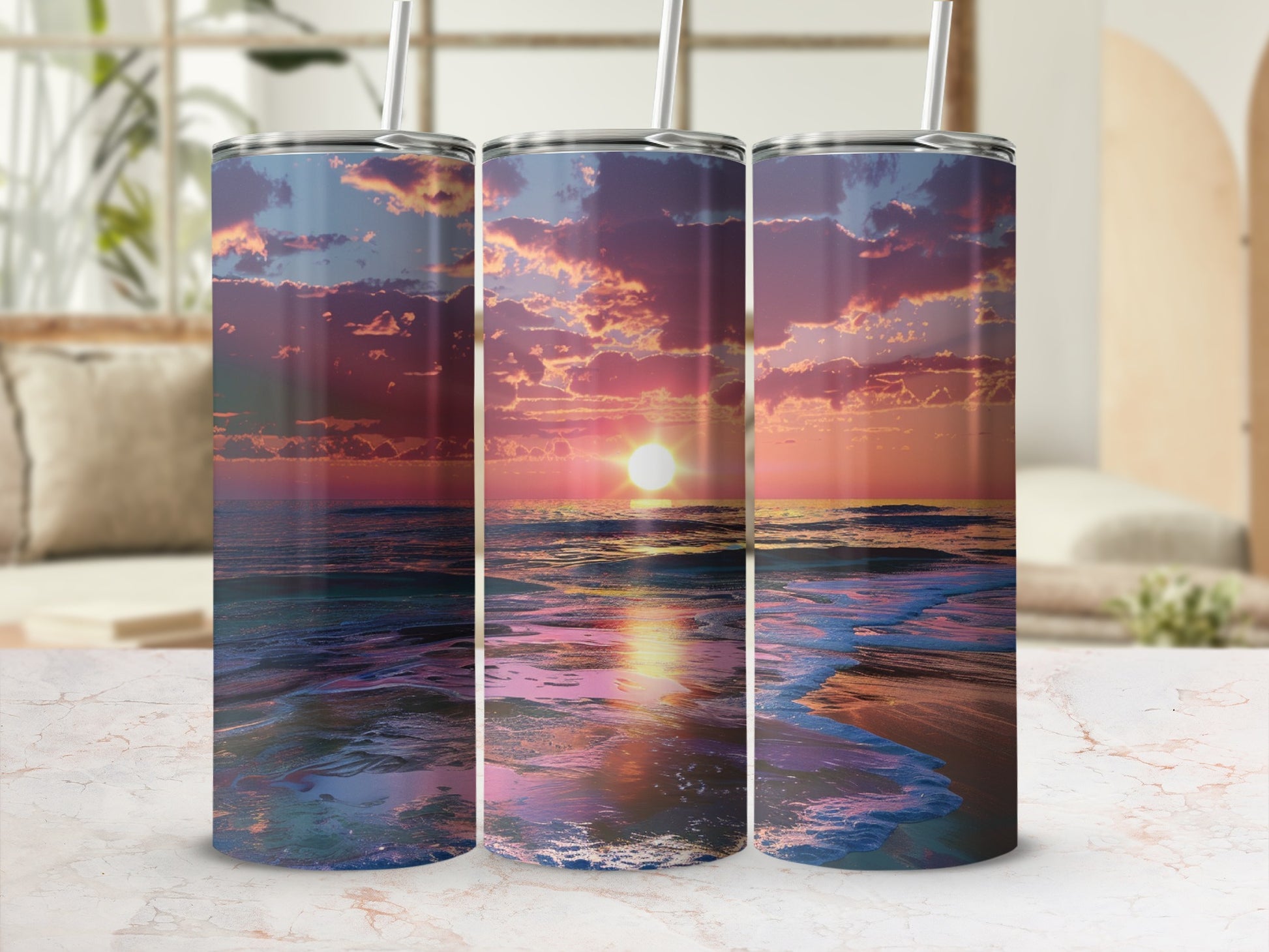 Three tumblers with a vibrant sunset beach scene wrap around them.