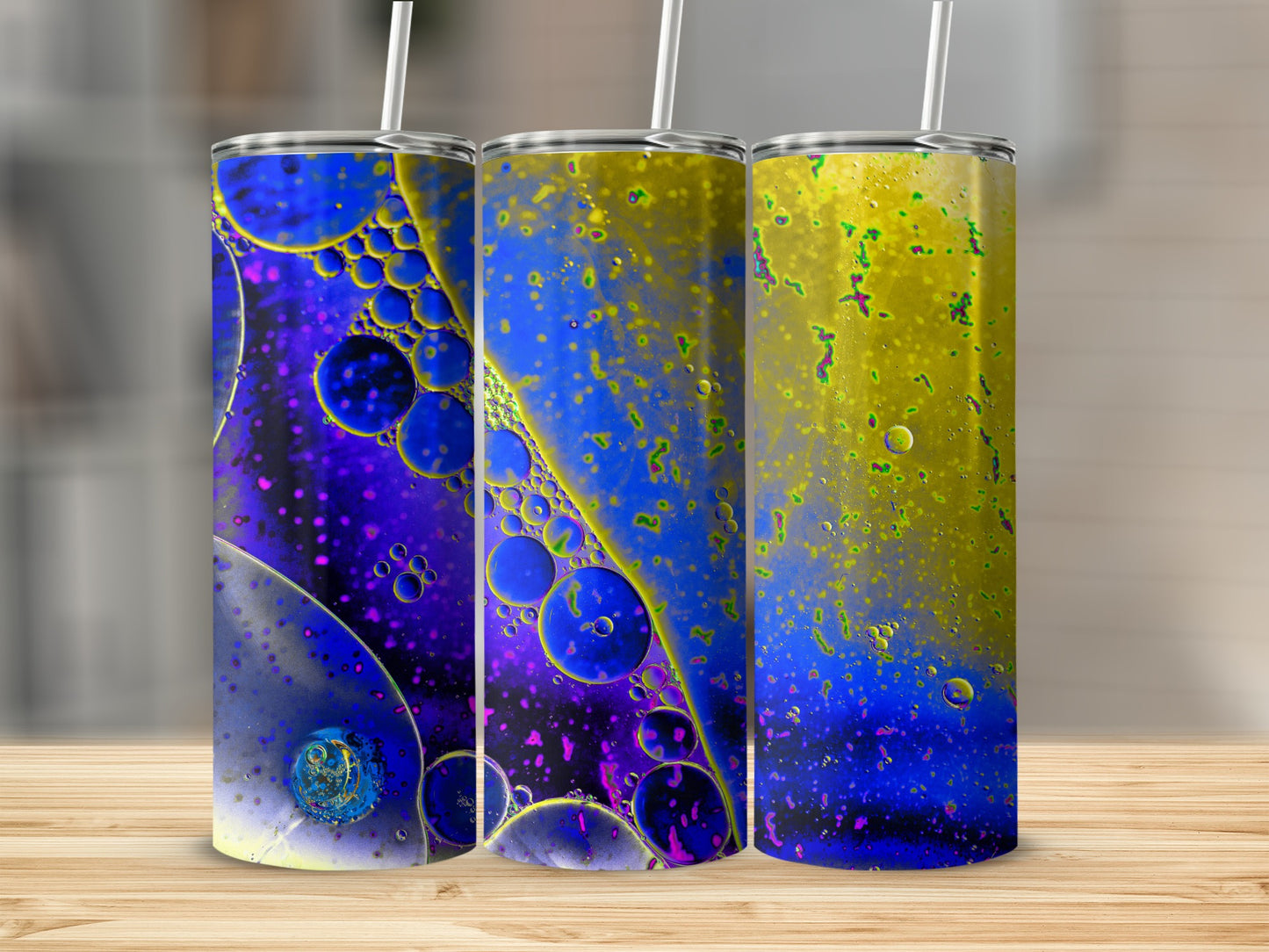 Three tumblers with a blue and yellow abstract oil and water design.