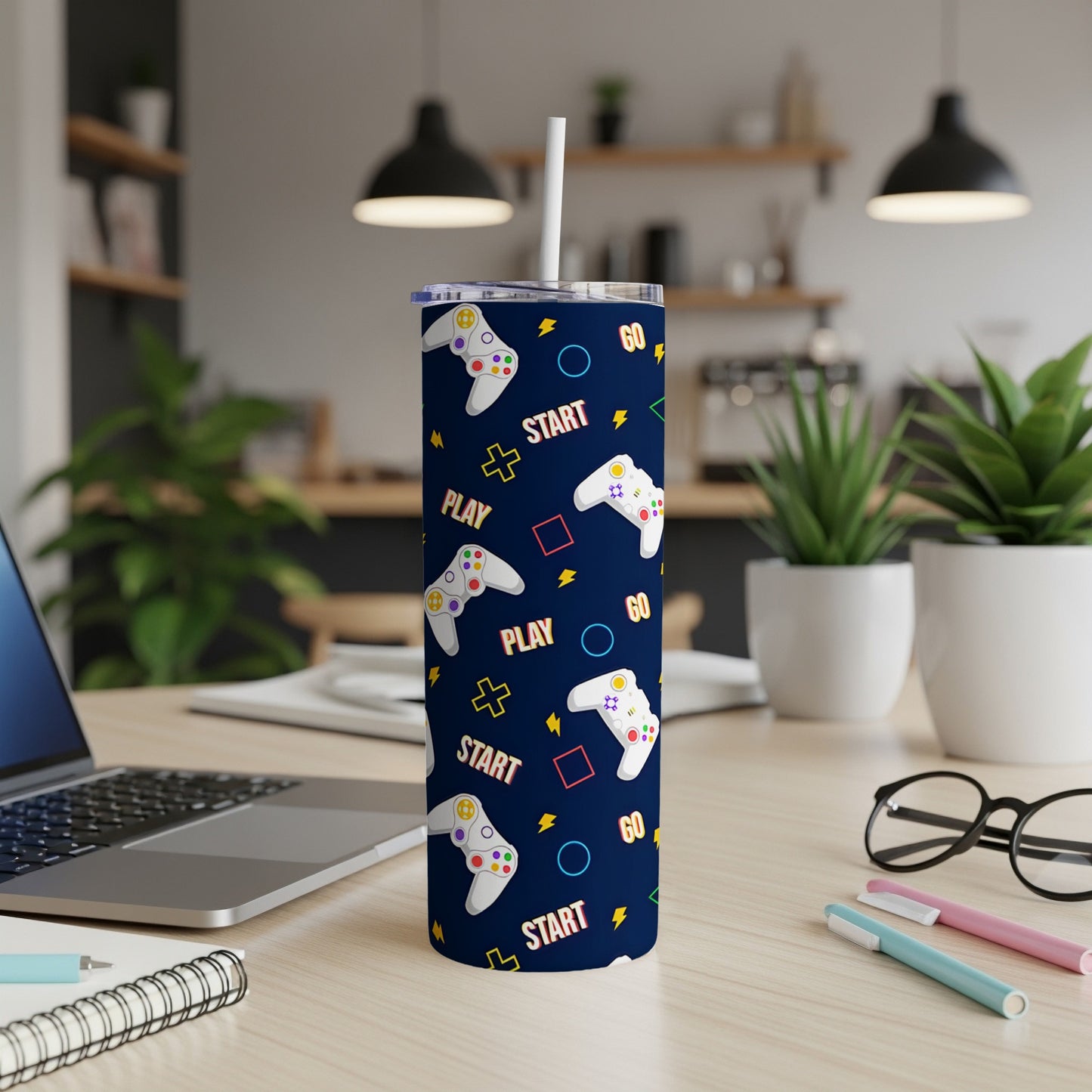 Dark blue tumbler with repeating pattern of white game controllers and "START" text.