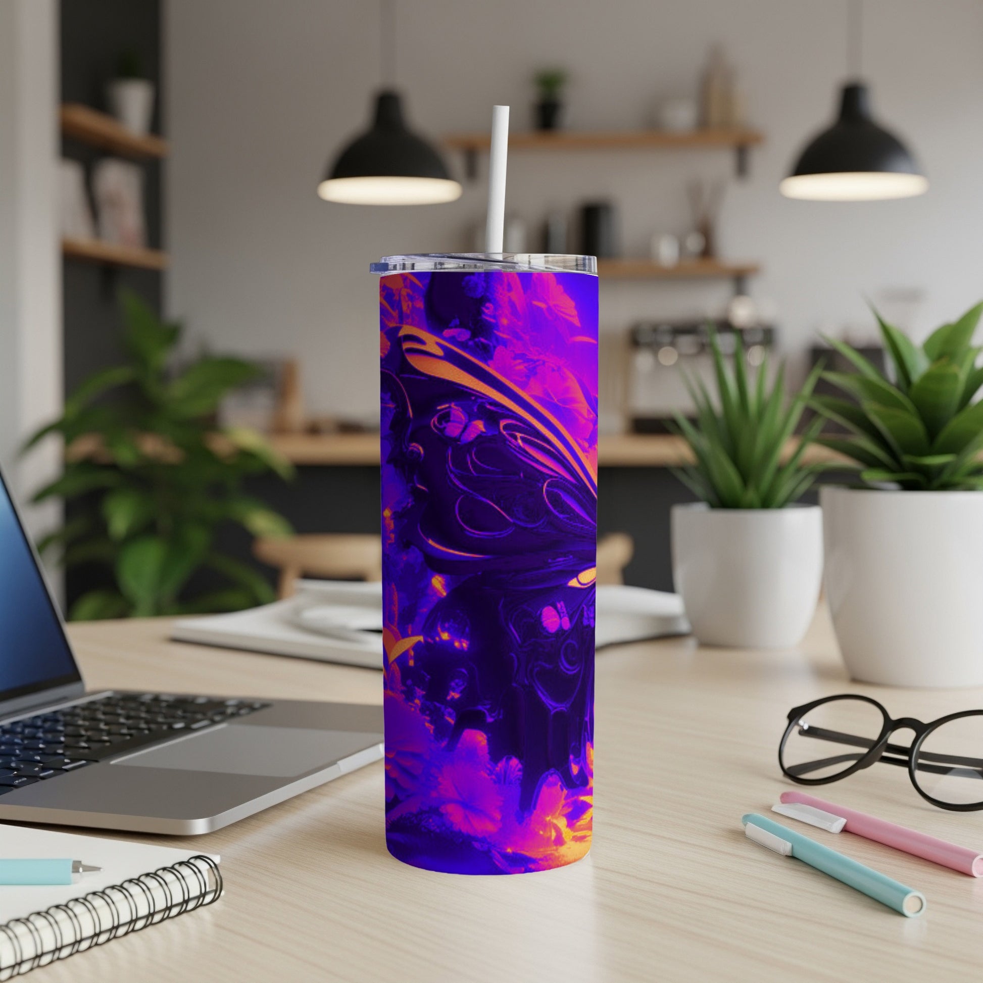 Purple and orange abstract design on a skinny tumbler with a straw.