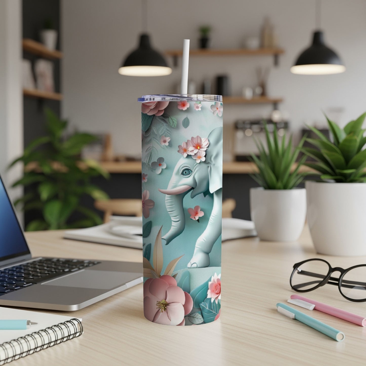 White elephant illustration on a pastel blue tumbler with floral accents.