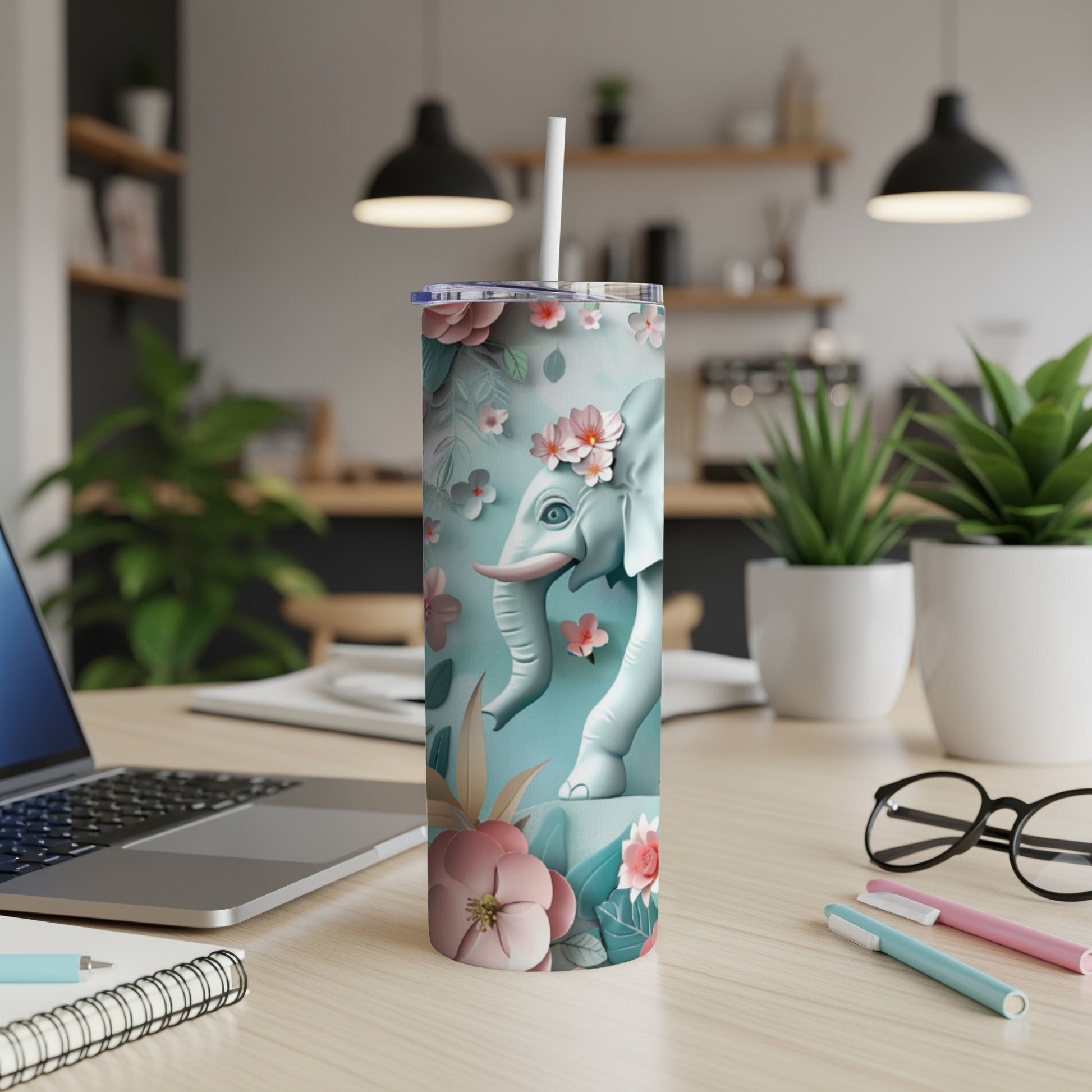 White elephant illustration on a pastel blue tumbler with floral accents.