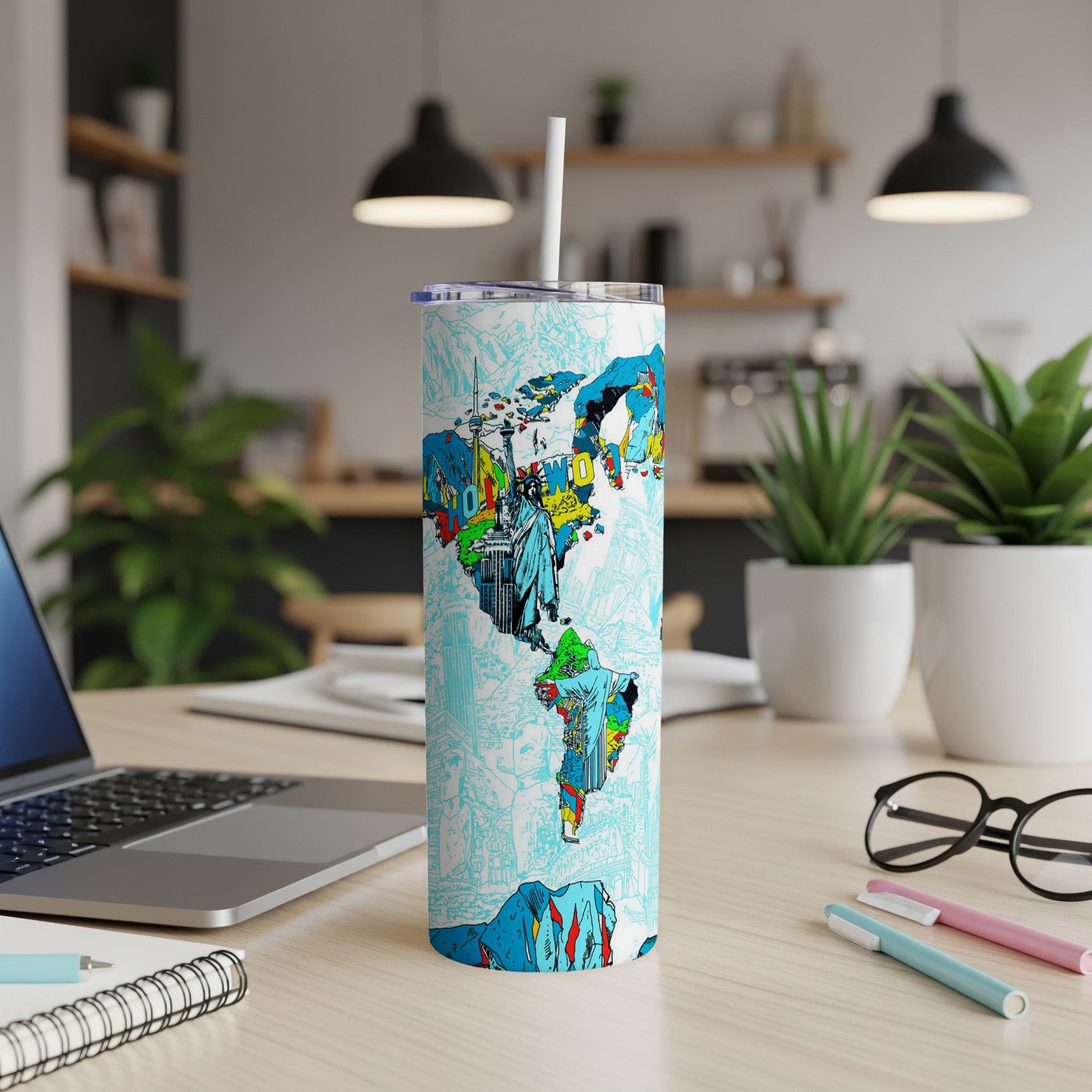 White tumbler with a colorful map of North and South America featuring landmarks.