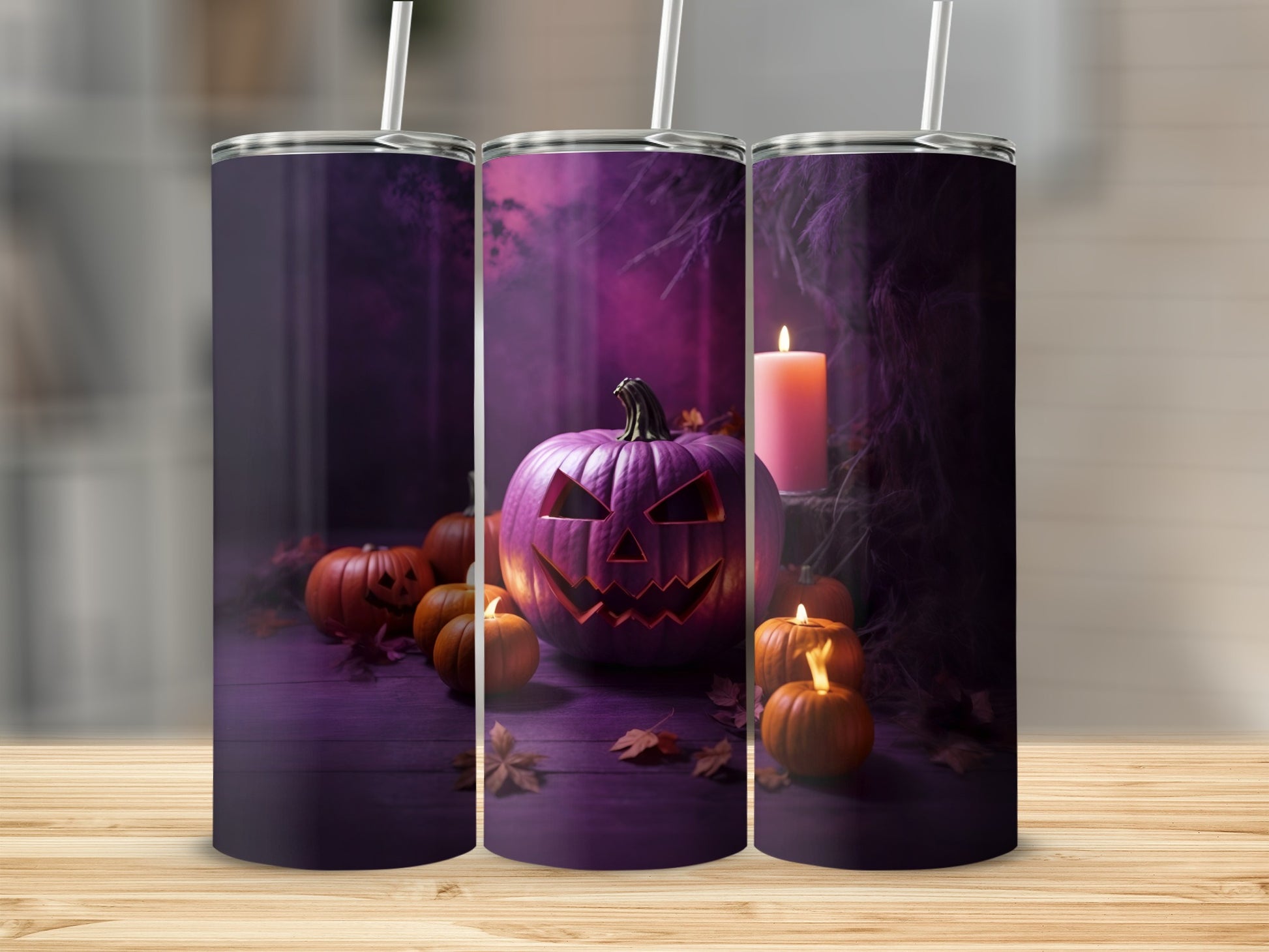 Three tumblers with a Halloween theme featuring jack-o'-lanterns and candles.