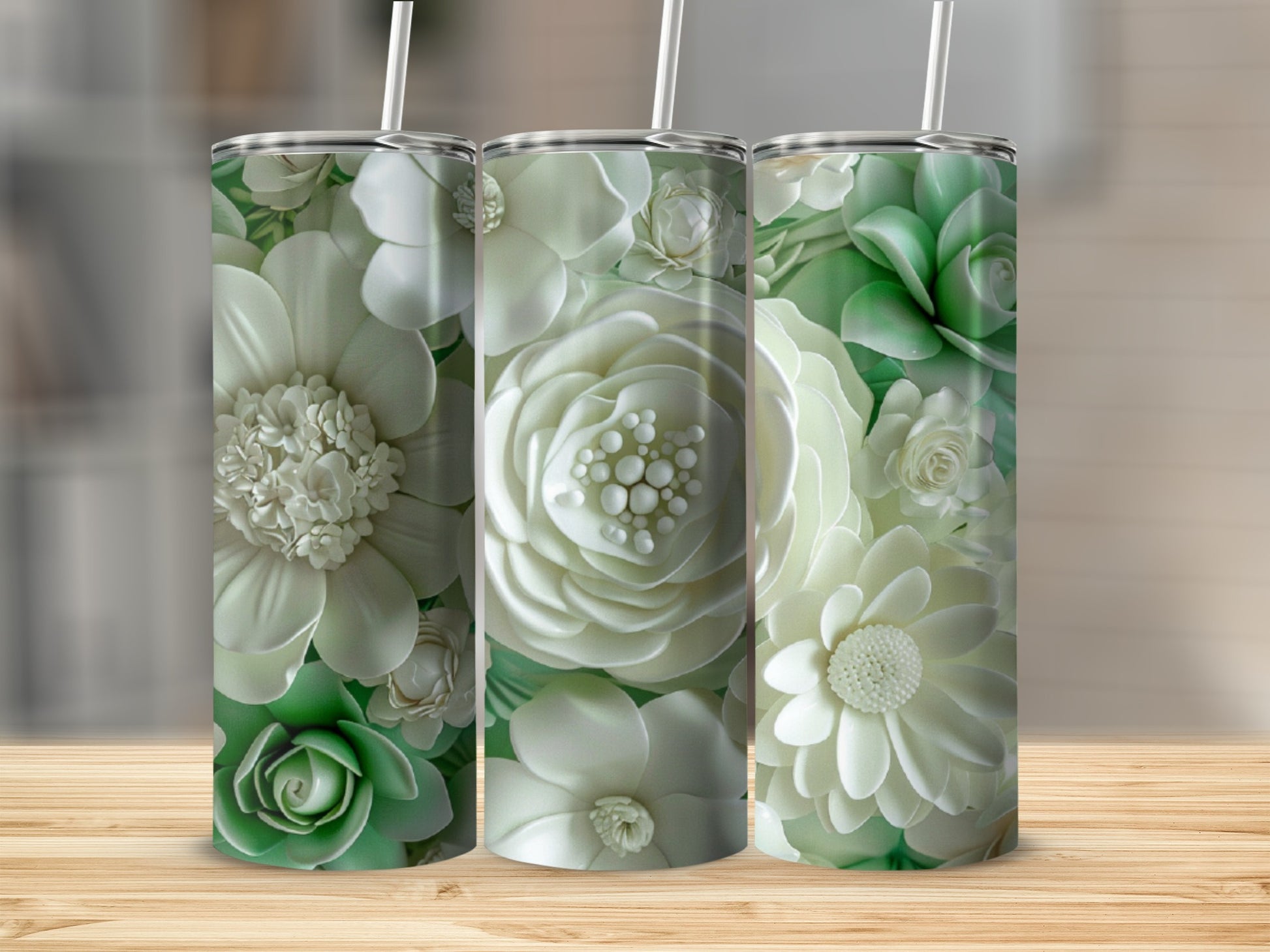 Three tumblers with detailed white and green floral designs.