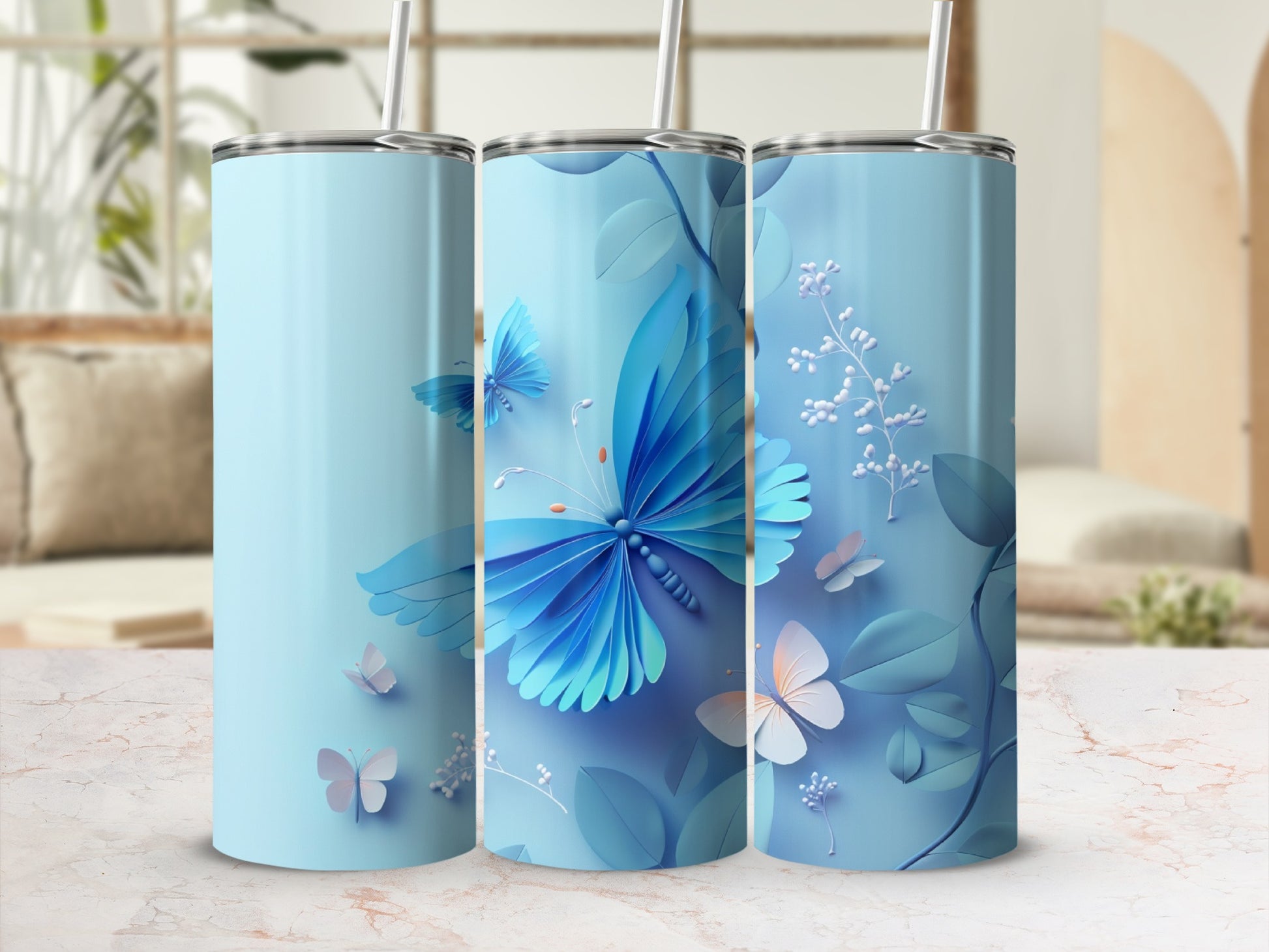 Blue tumbler with butterflies and floral accents on a light background.
