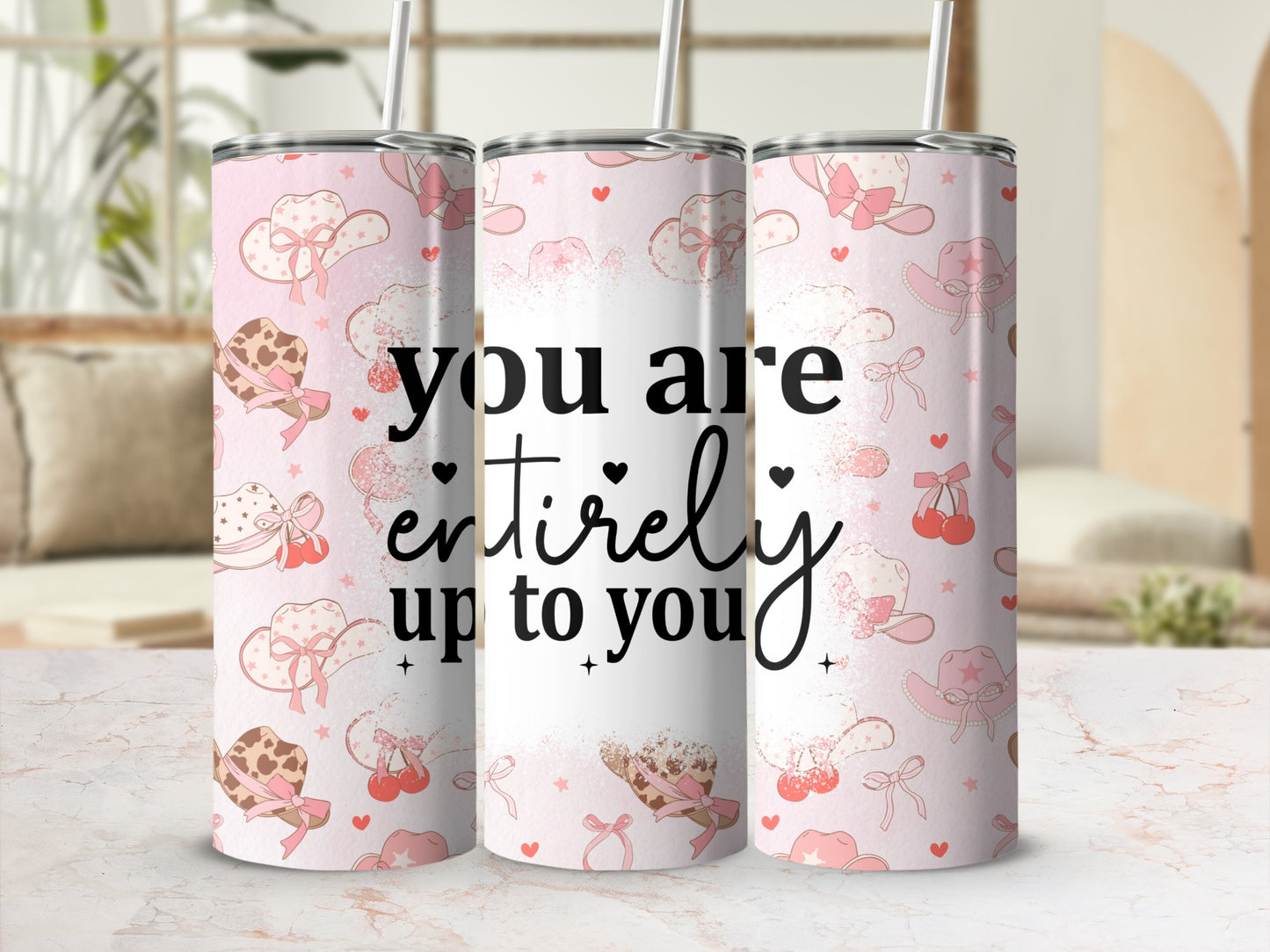 Pink cowgirl tumbler with hats, cherries, and text "you are entirely up to you".