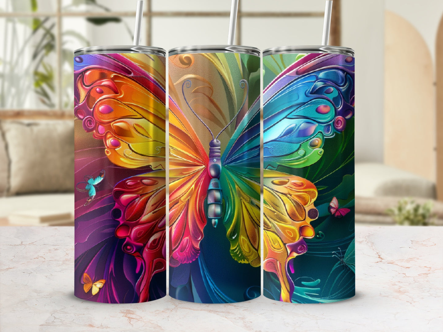 Rainbow butterfly design on three tumblers with straws.