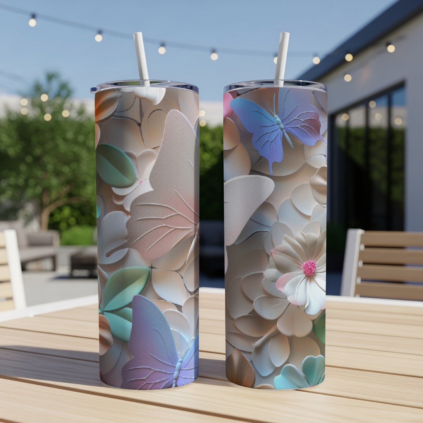 Two tumblers with pastel butterflies and floral embossed pattern on a table.